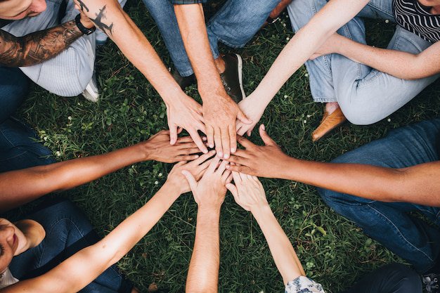 people-stacking-hands-together-park_53876-63293.jpg