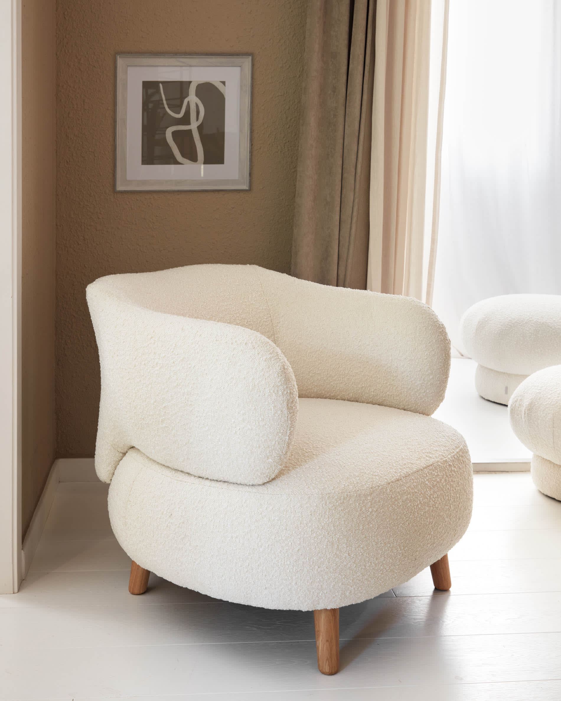 Luisa white boucle armchair with solid rubber wood legs. Kave Home