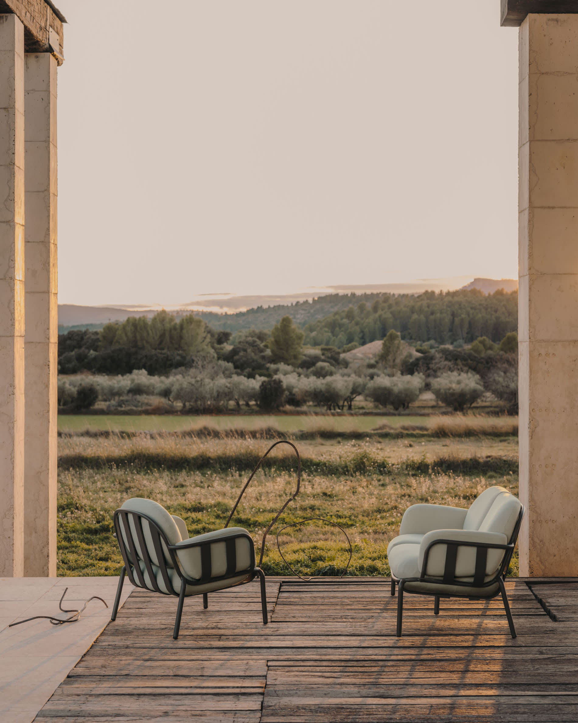 Joncols outdoor armchair in aluminium with green painted finish and beige cushions
