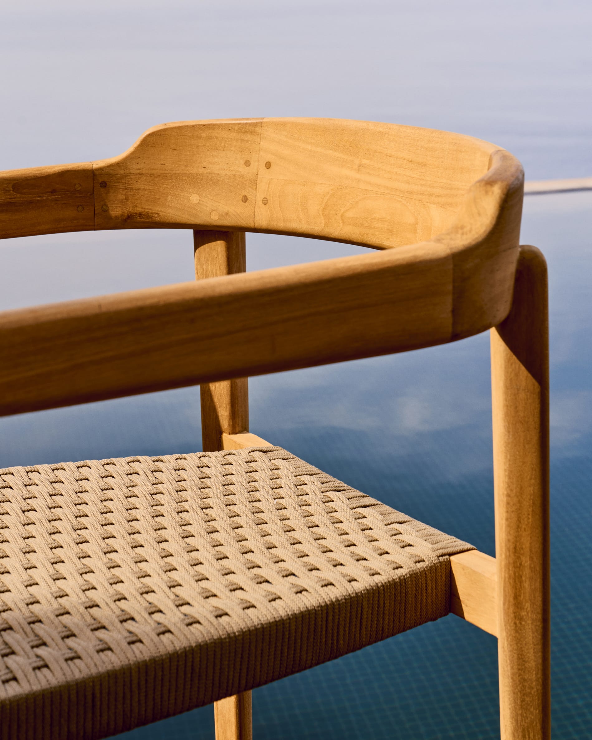 Icaro stackable chair in FSC 100% solid teak wood with natural finish and beige rope cord