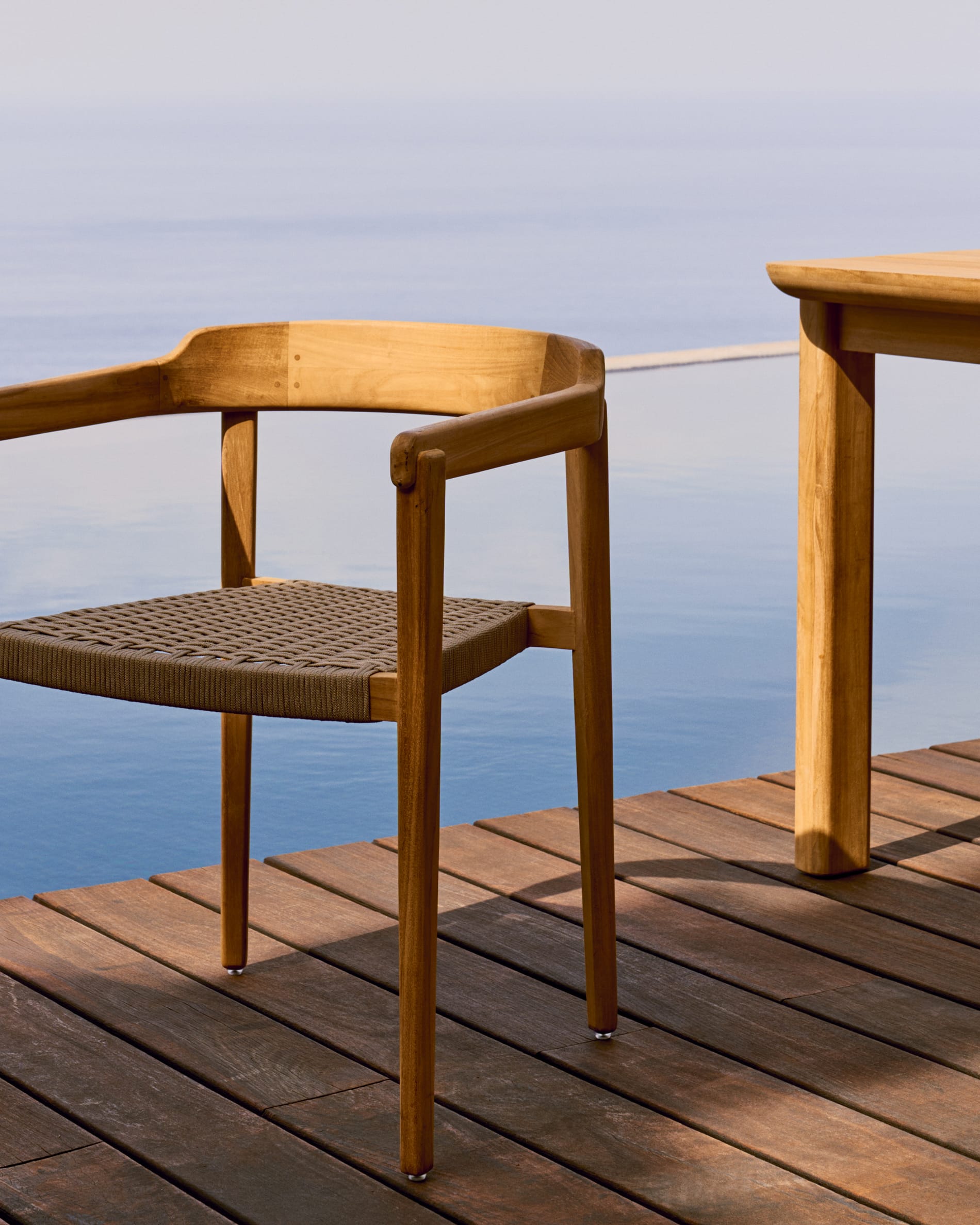 Icaro stackable chair in FSC 100% solid teak wood with natural finish and beige rope cord