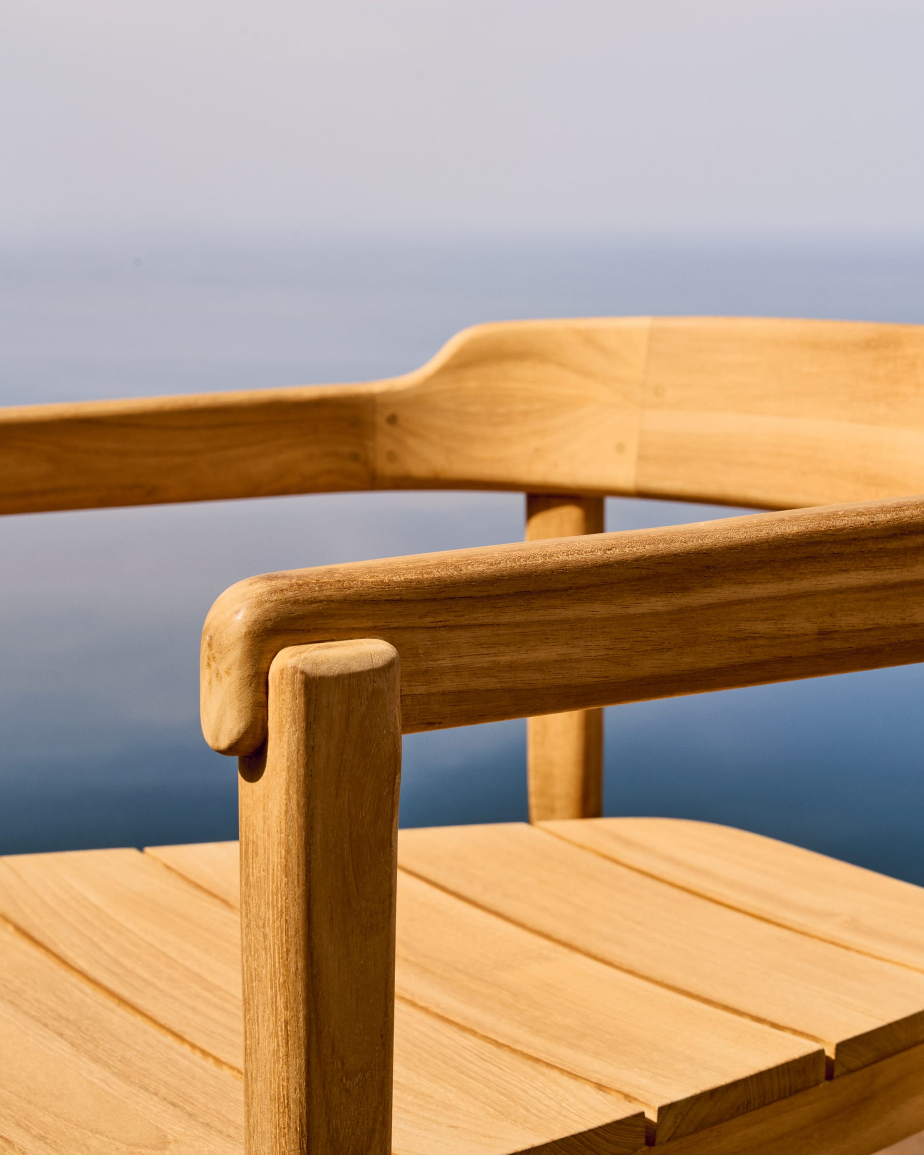 Icaro stackable chair in FSC 100% solid teak wood with natural finish
