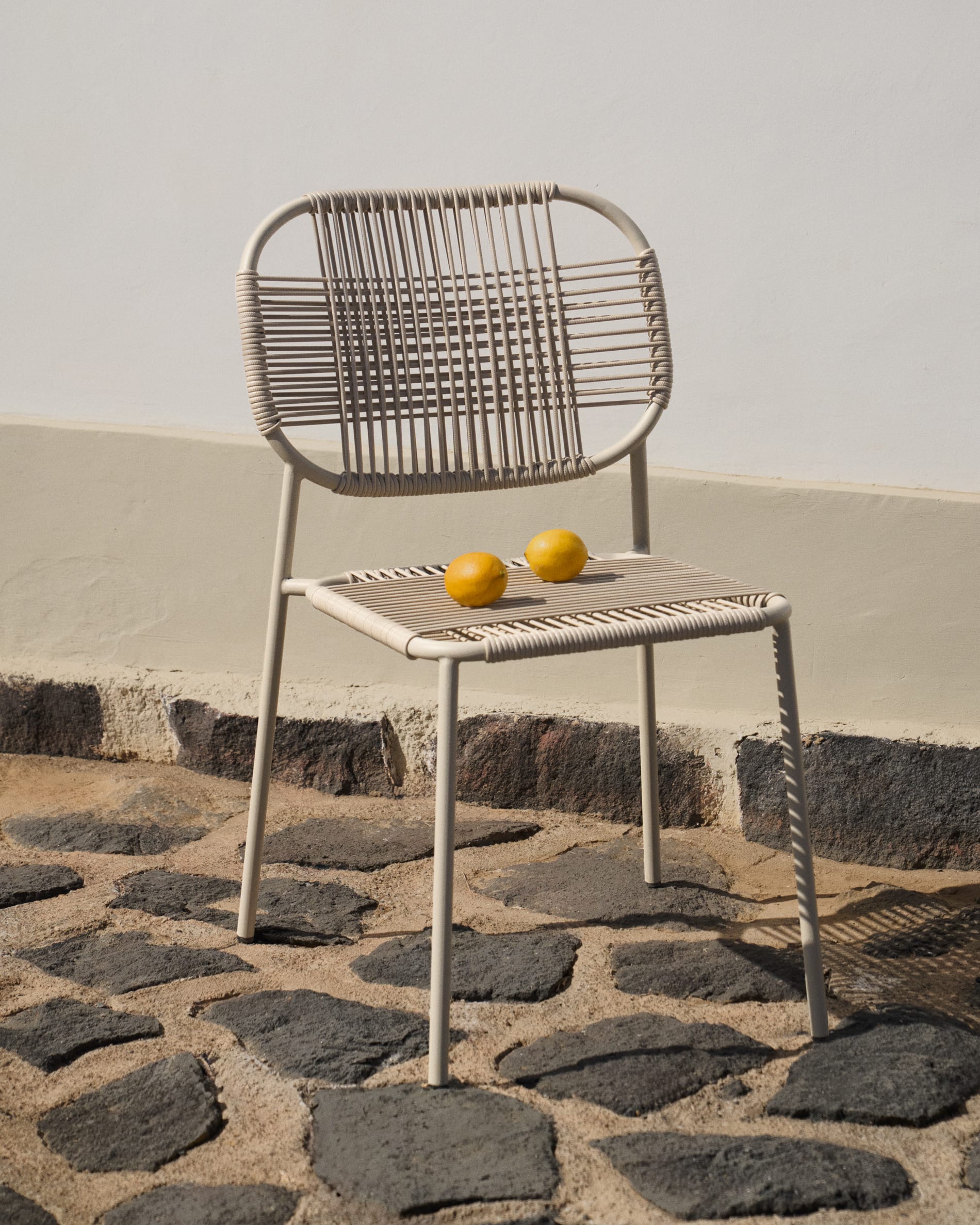 Talaier stackable outdoor chair in synthetic rope and galvanised steel with beige finish