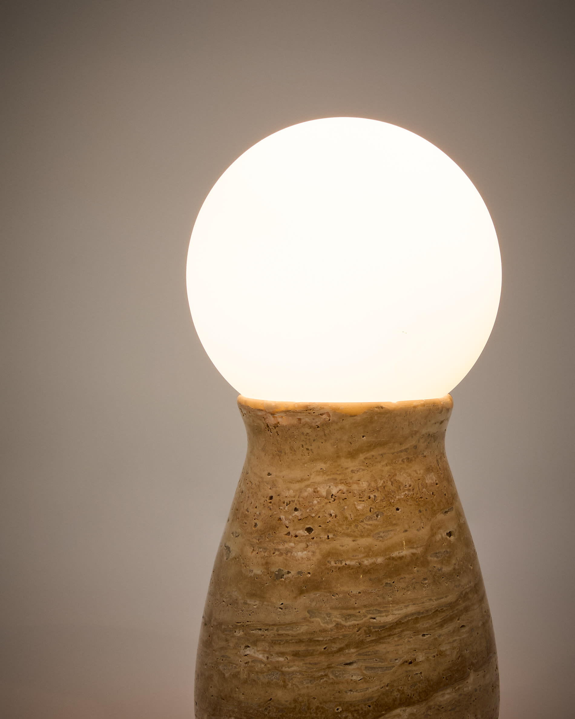 Okeni table lamp made of travertine and glass