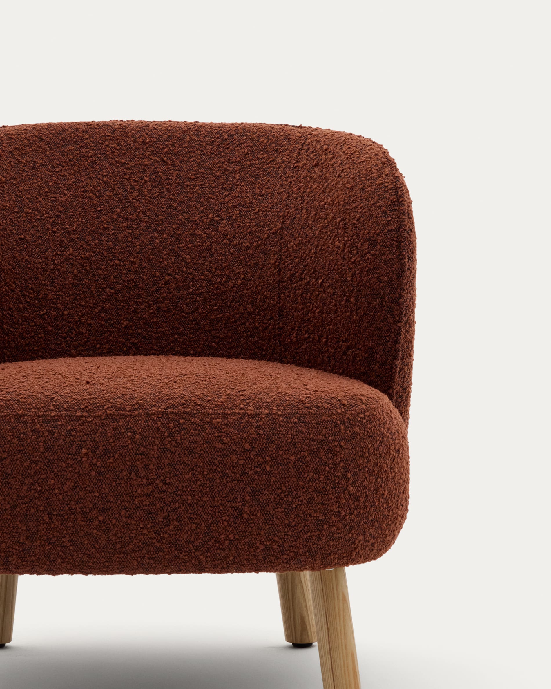 Ulit armchair in terracotta bouclé with solid ash wood legs in a natural finish