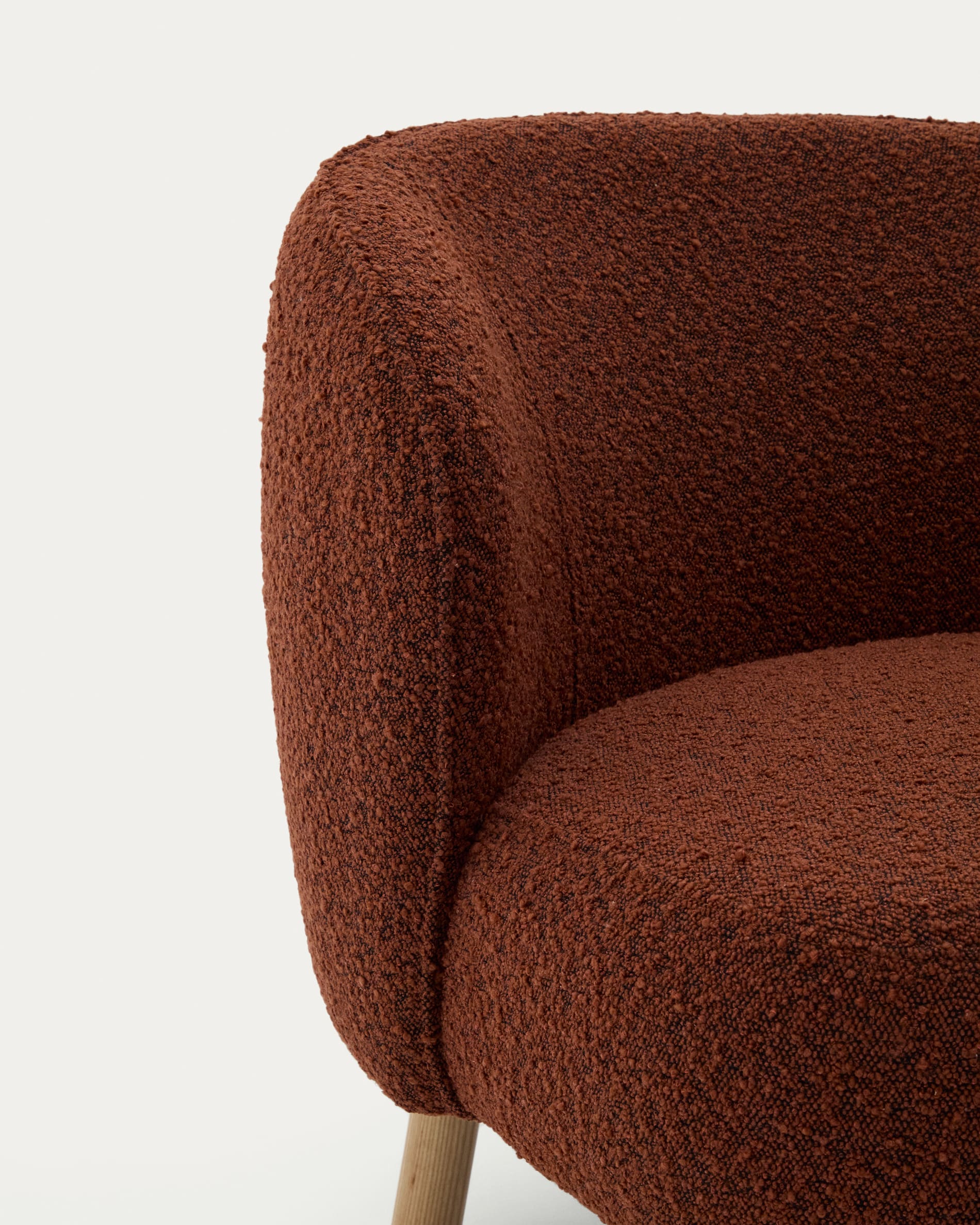 Ulit armchair in terracotta bouclé with solid ash wood legs in a natural finish