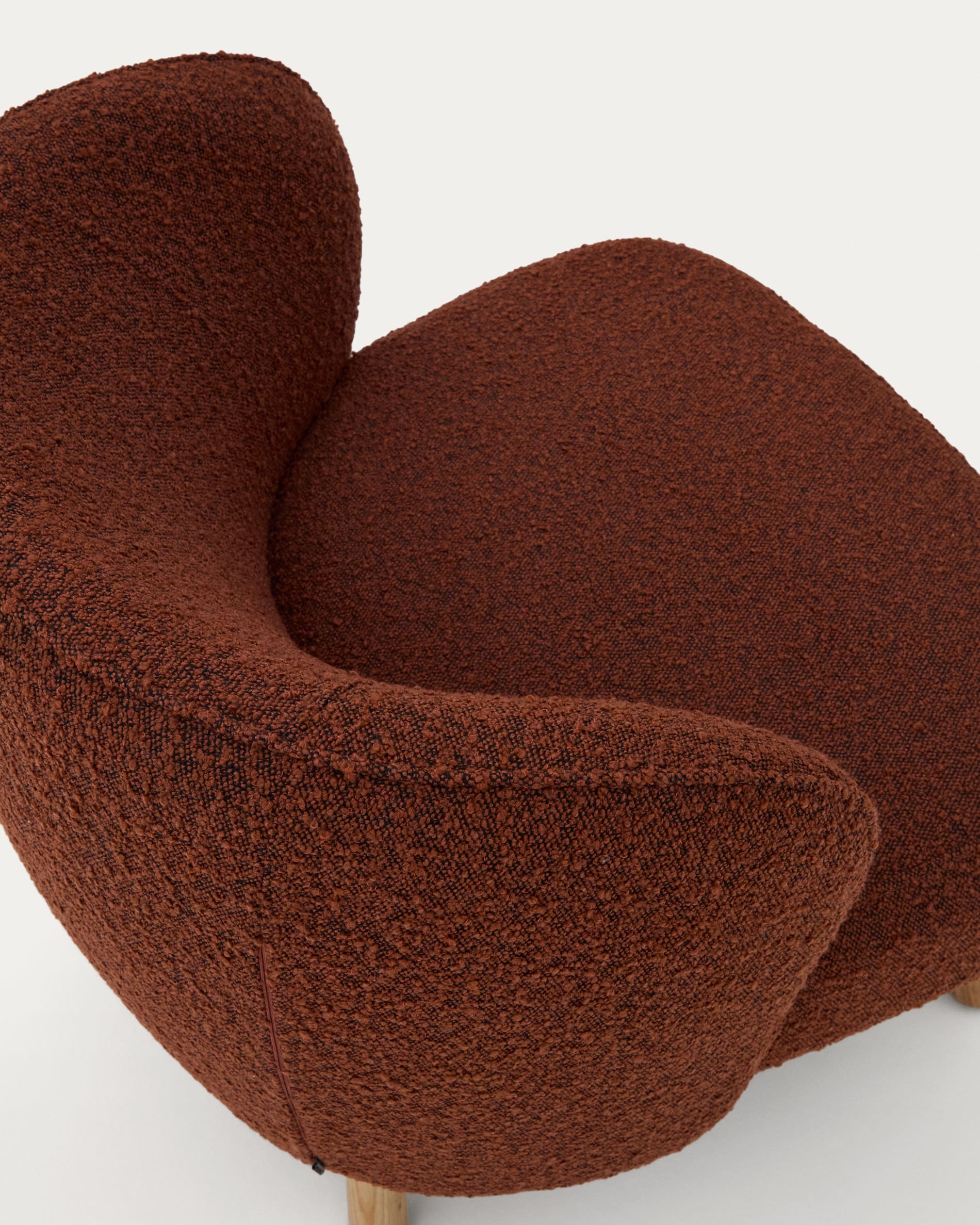 Ulit armchair in terracotta bouclé with solid ash wood legs in a natural finish