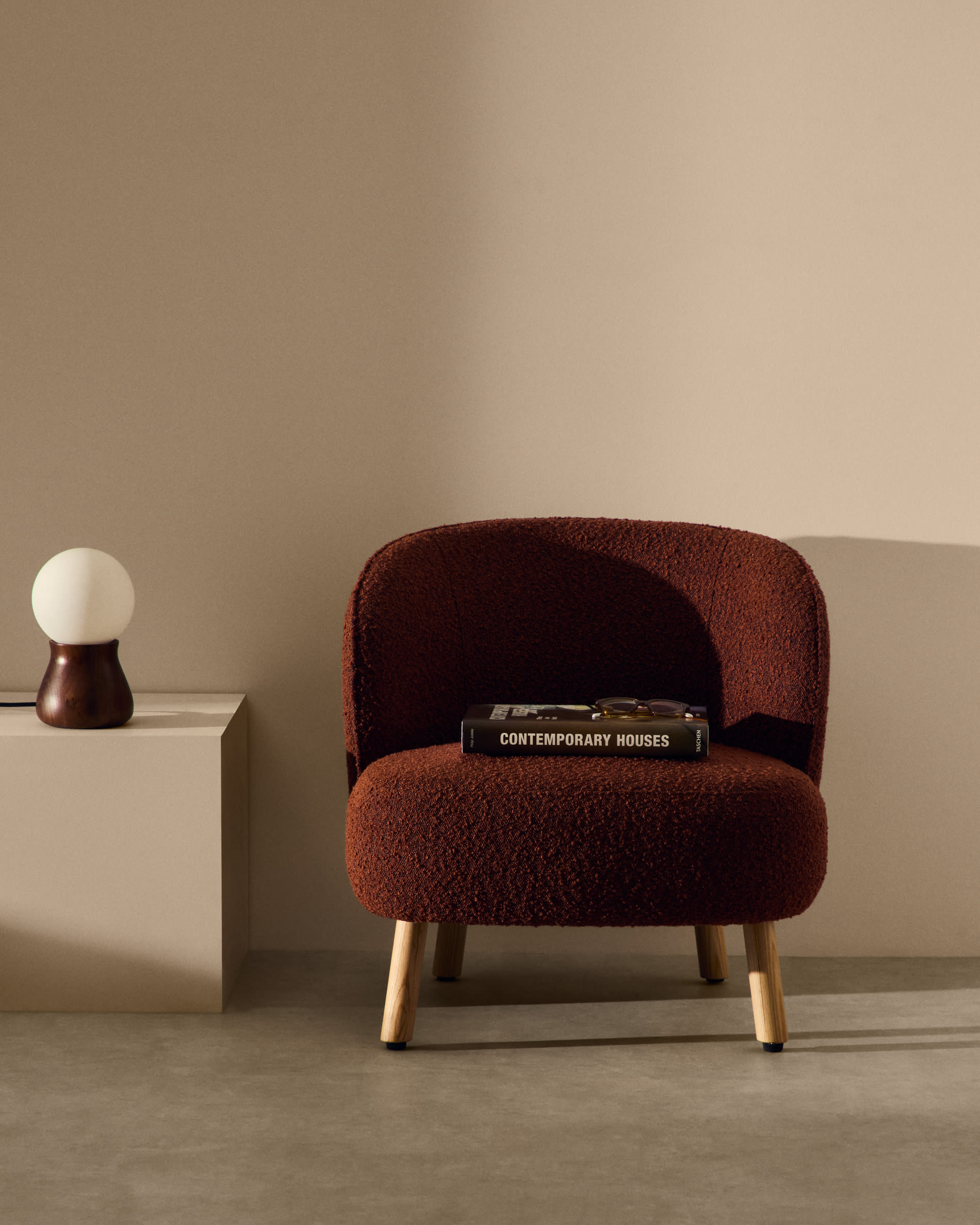 Ulit armchair in terracotta bouclé with solid ash wood legs in a natural finish