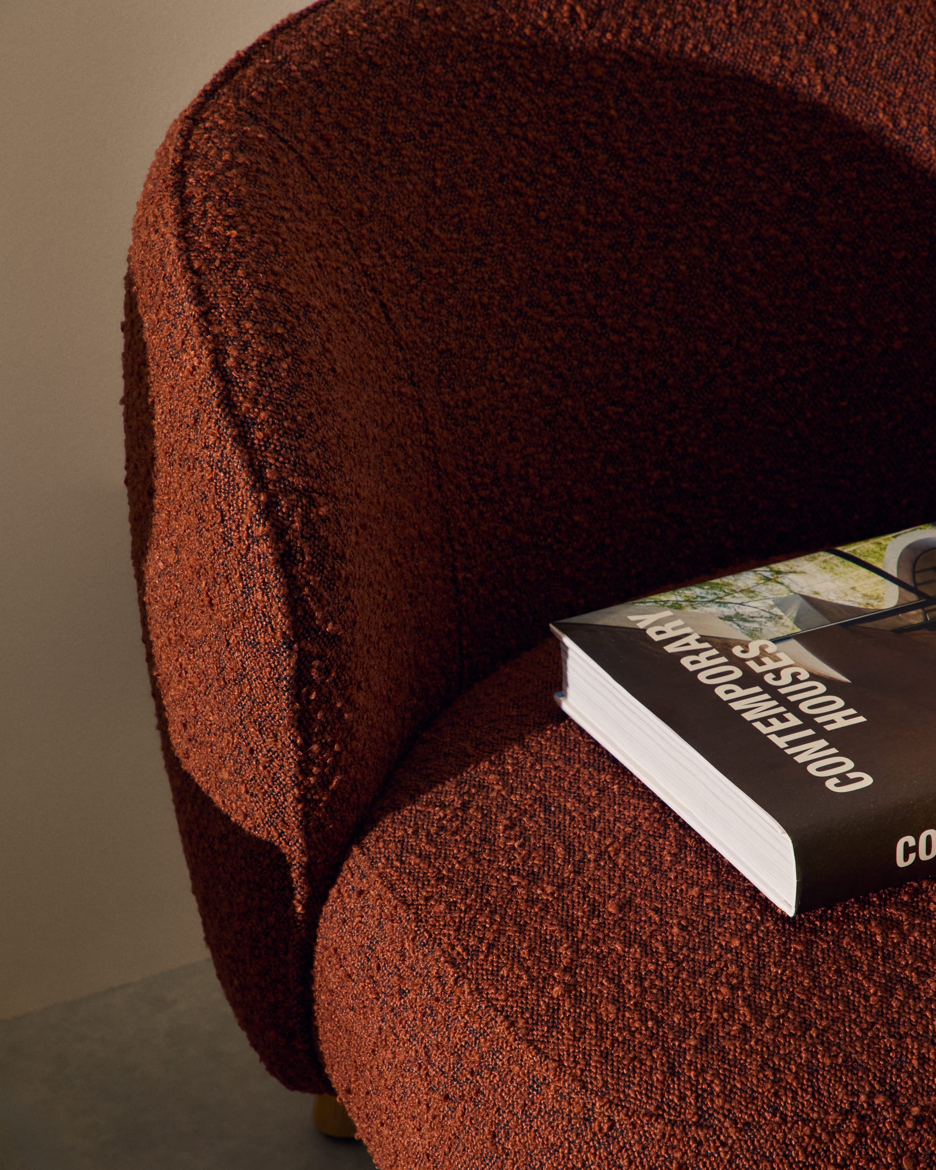 Ulit armchair in terracotta bouclé with solid ash wood legs in a natural finish