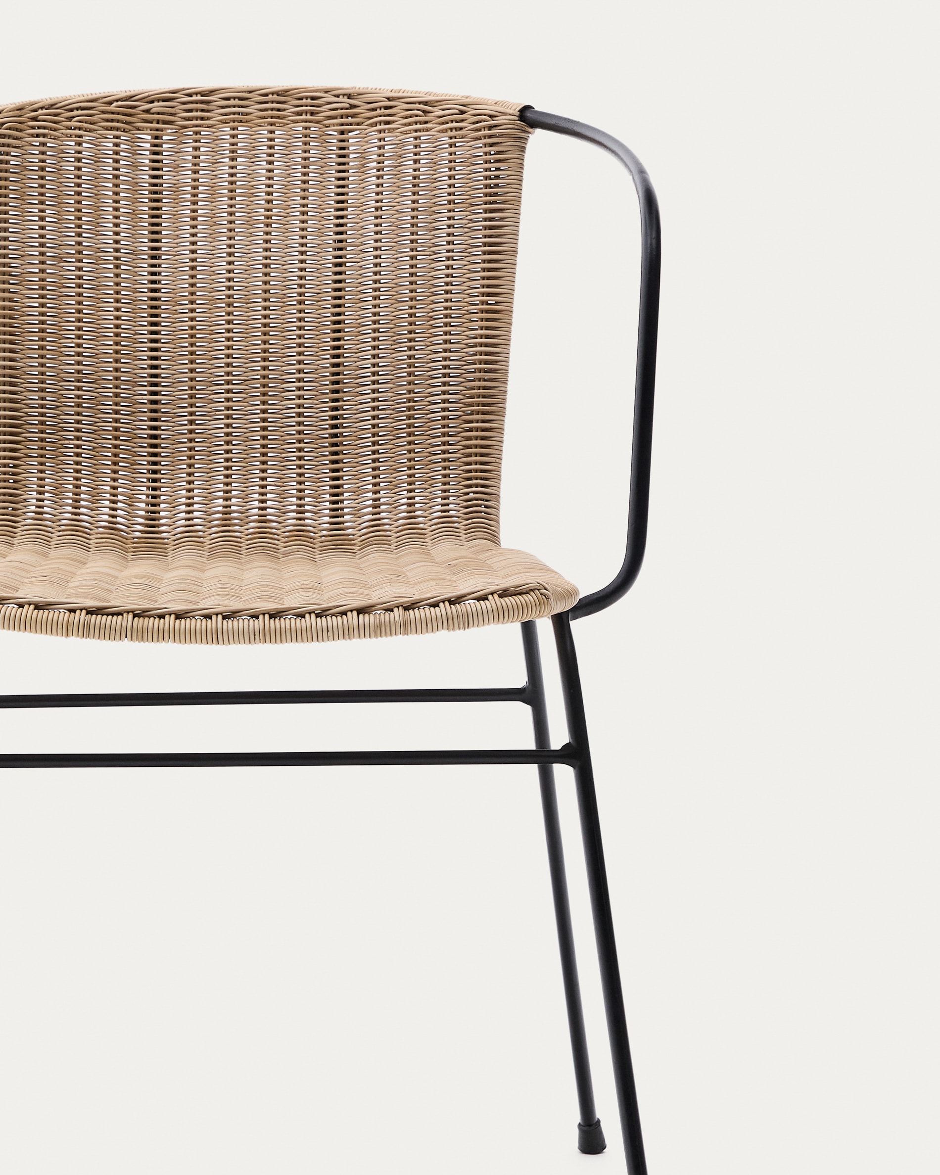 Eltiera stackable chair in synthetic rattan with black steel frame and armrests