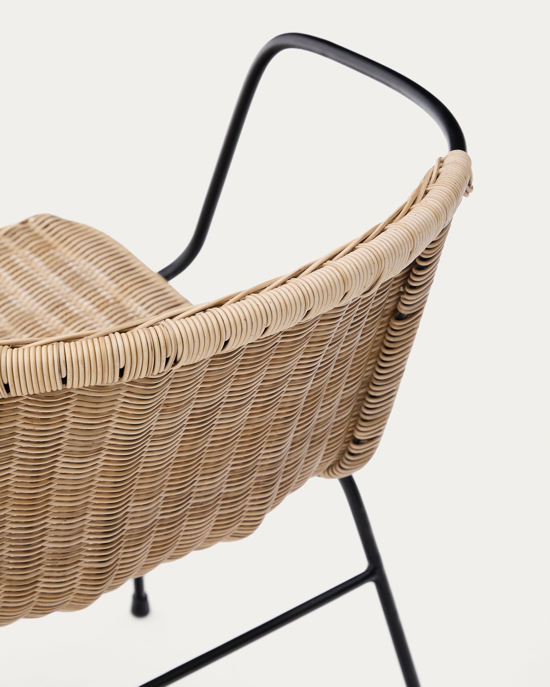 Eltiera stackable chair in synthetic rattan with black steel frame and armrests