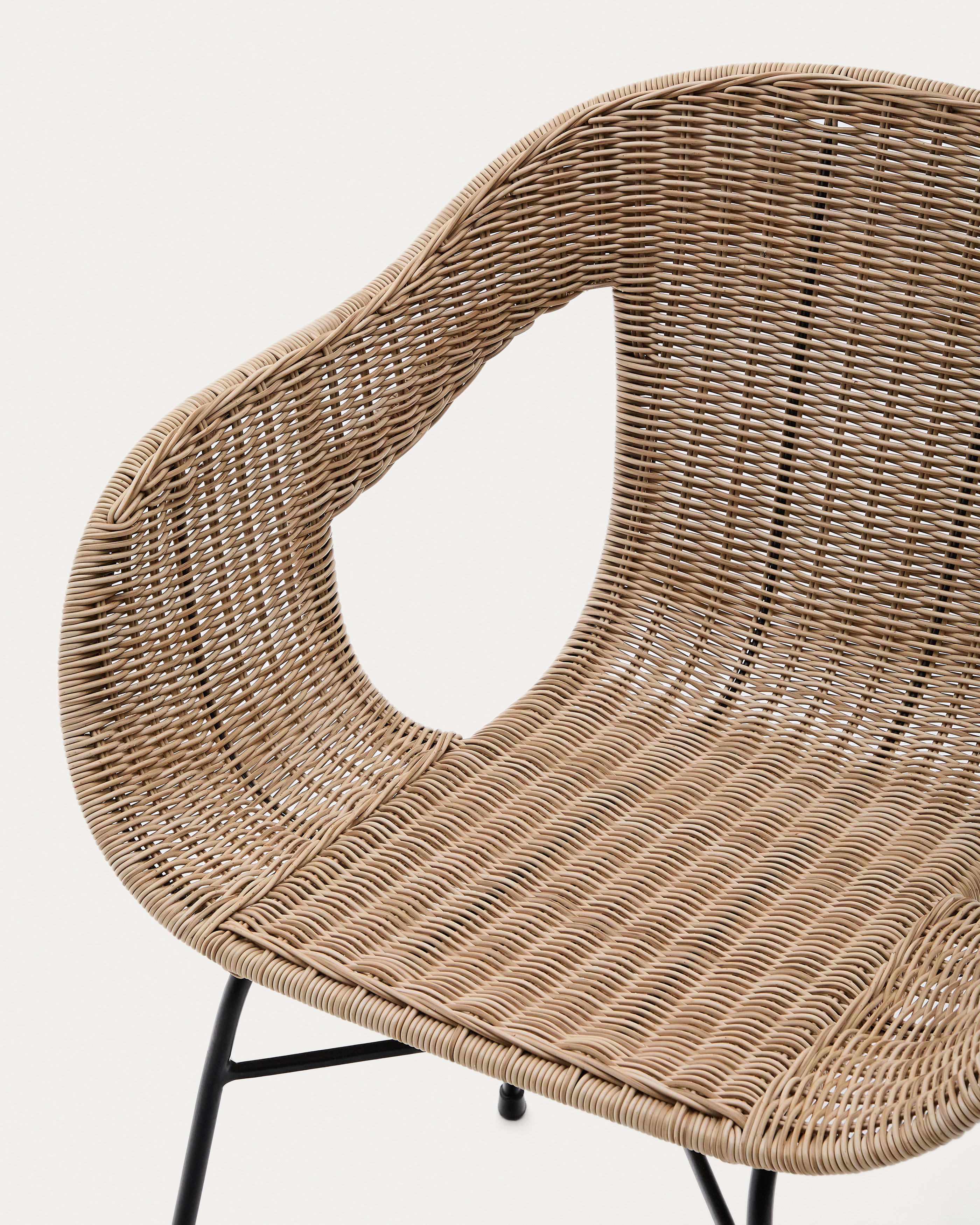 Eltiera stackable chair in synthetic rattan with black steel frame