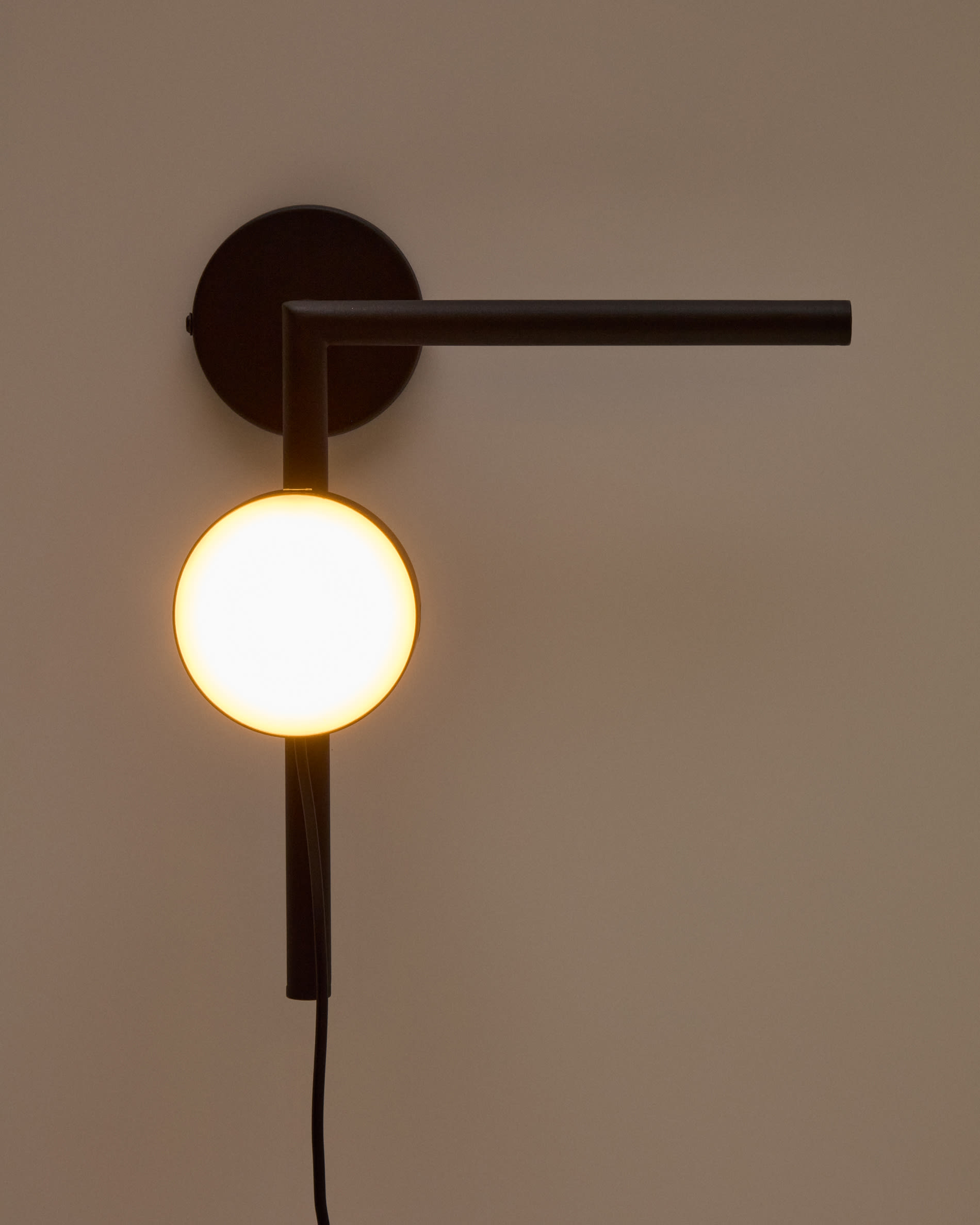 Orey black metal wall-mounted light fixture with multi-position spotlight
