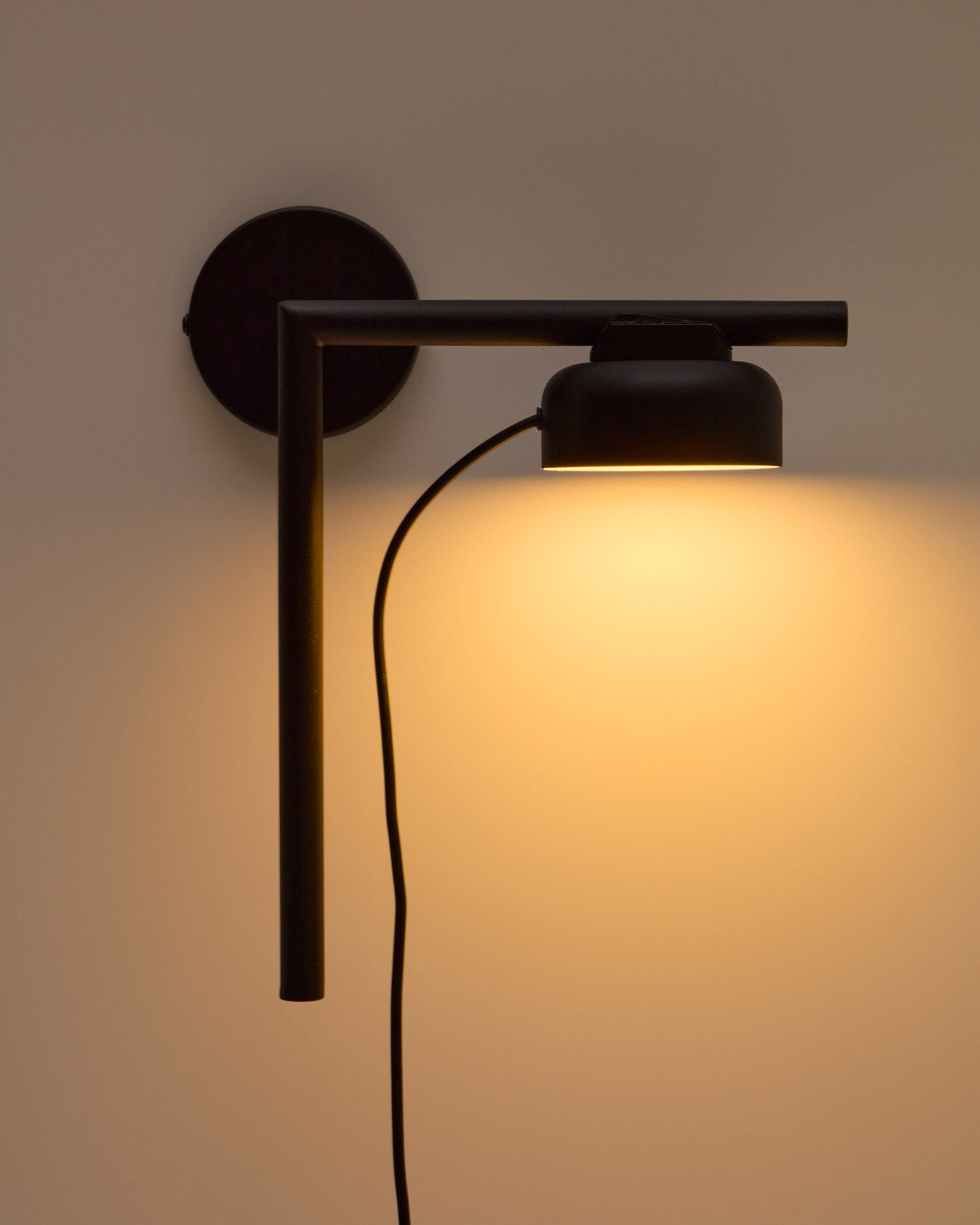 Orey black metal wall-mounted light fixture with multi-position spotlight