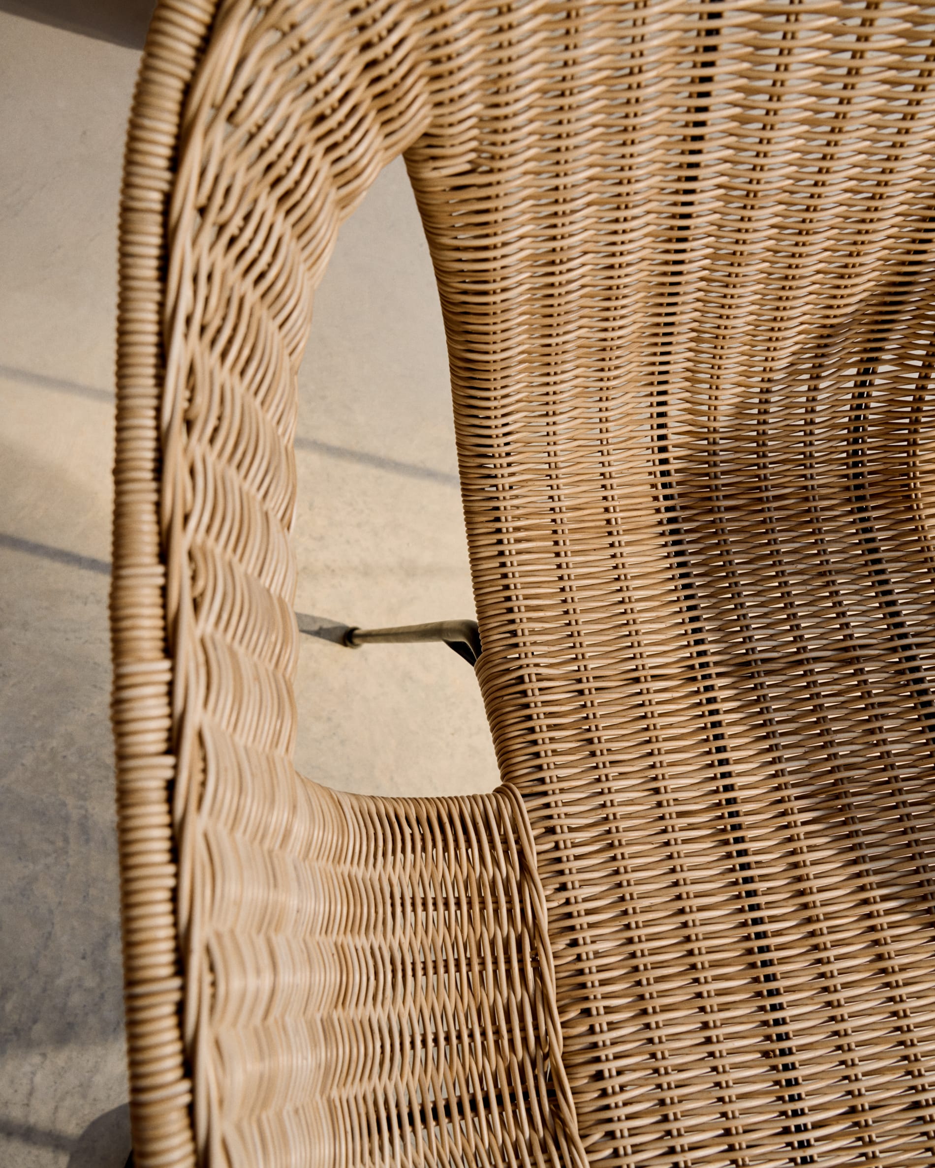 Eltiera stackable chair in synthetic rattan with black steel frame