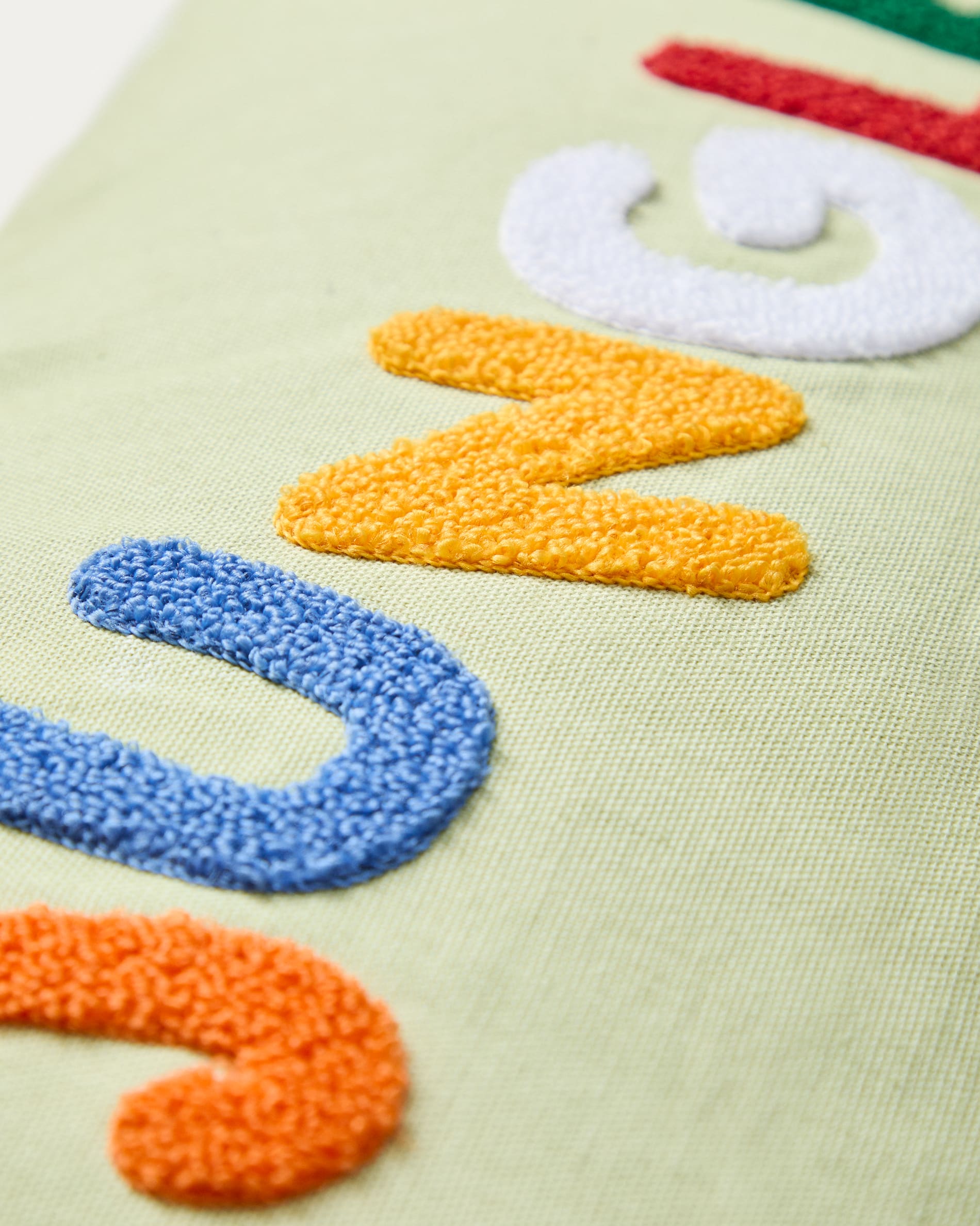 Tandani green cotton cushion cover with multicoloured embroidered lettering 30 x 50cm