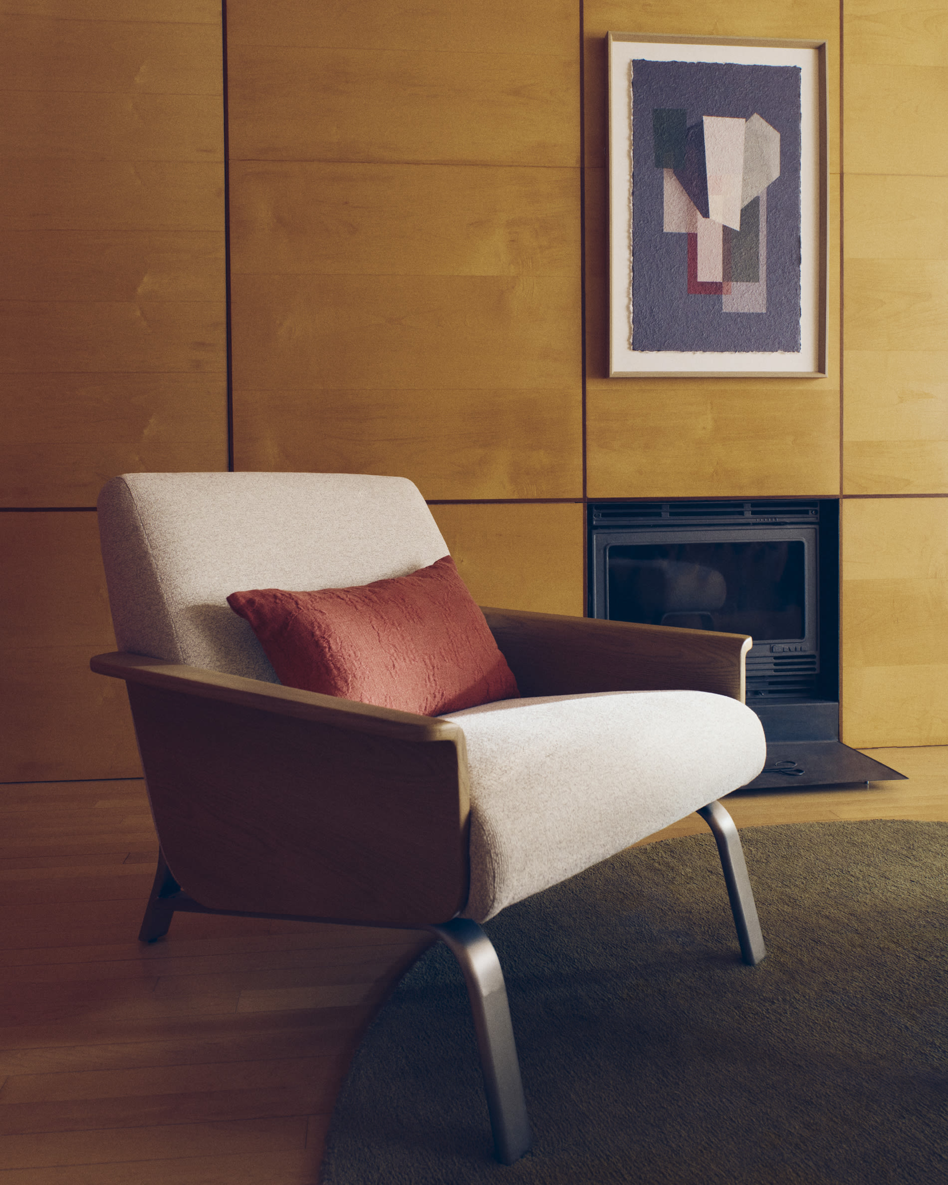 Amsen beige armchair in oak plywood with legs in brushed stainless steel