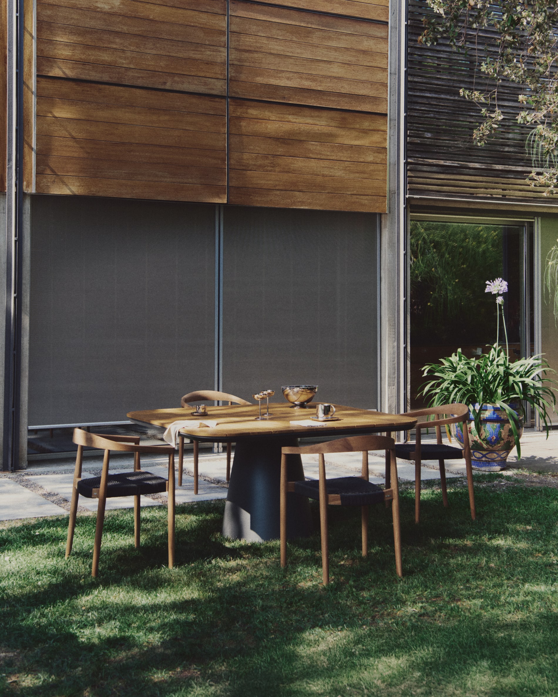Ydalia stackable outdoor chair in solid teak wood with natural finish and black rope