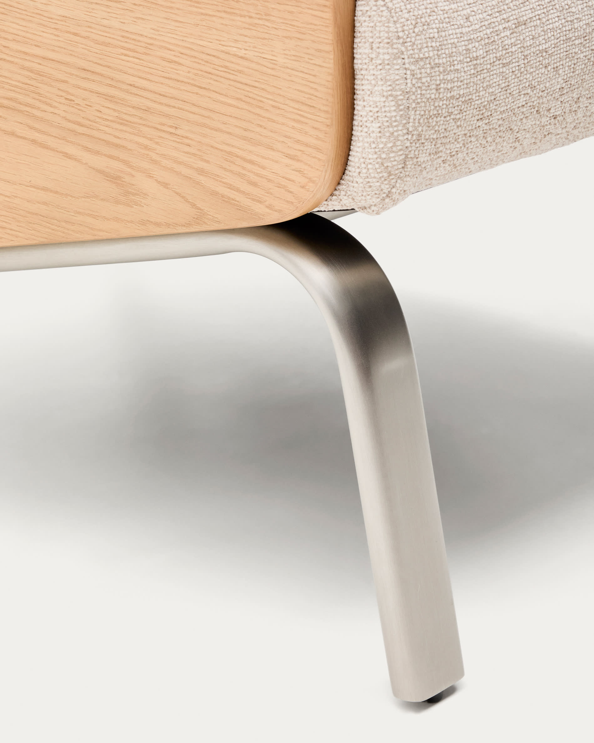 Amsen beige armchair in oak plywood with legs in brushed stainless steel