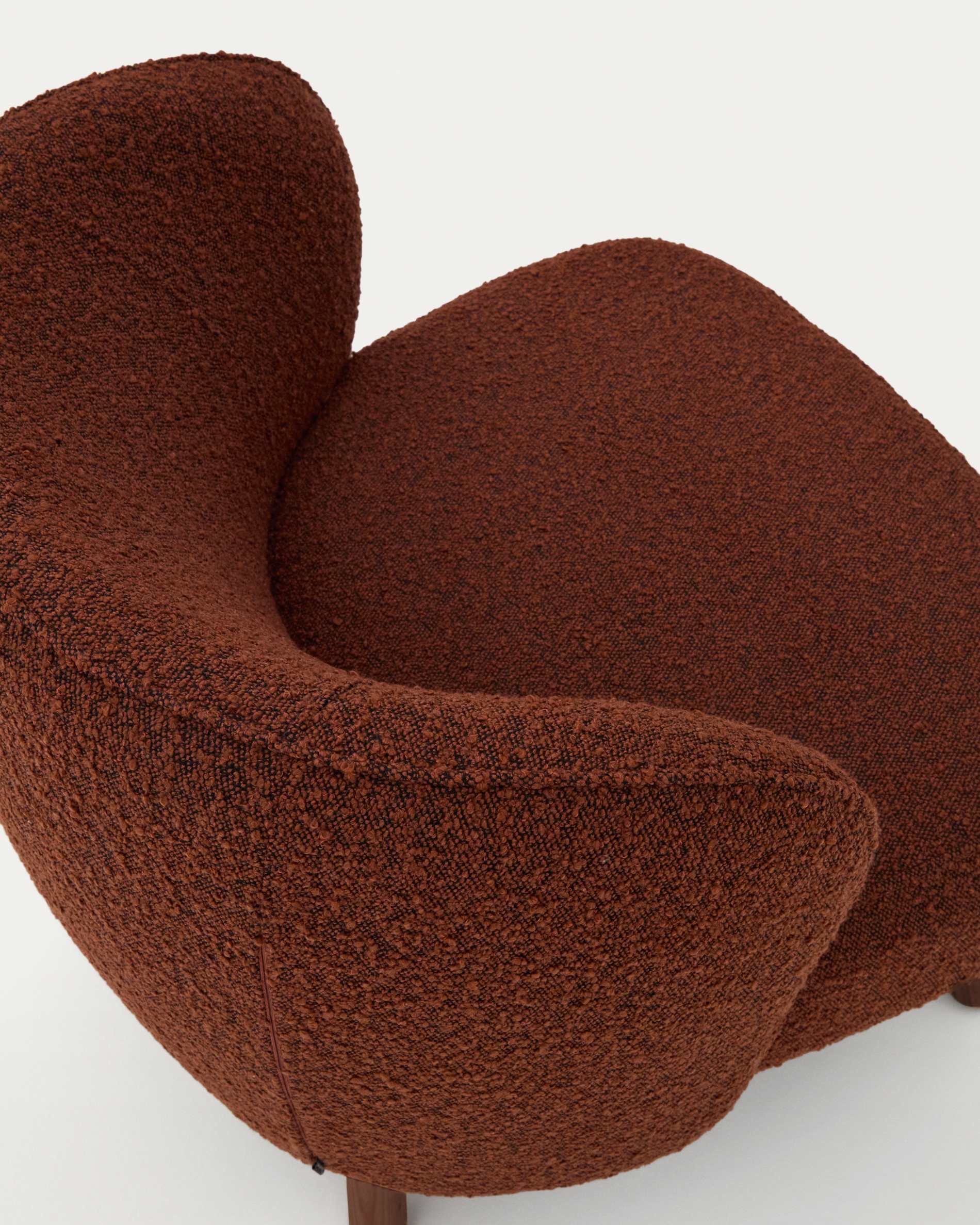 Ulit armchair in terracotta bouclé with solid ash wood legs in a walnut finish