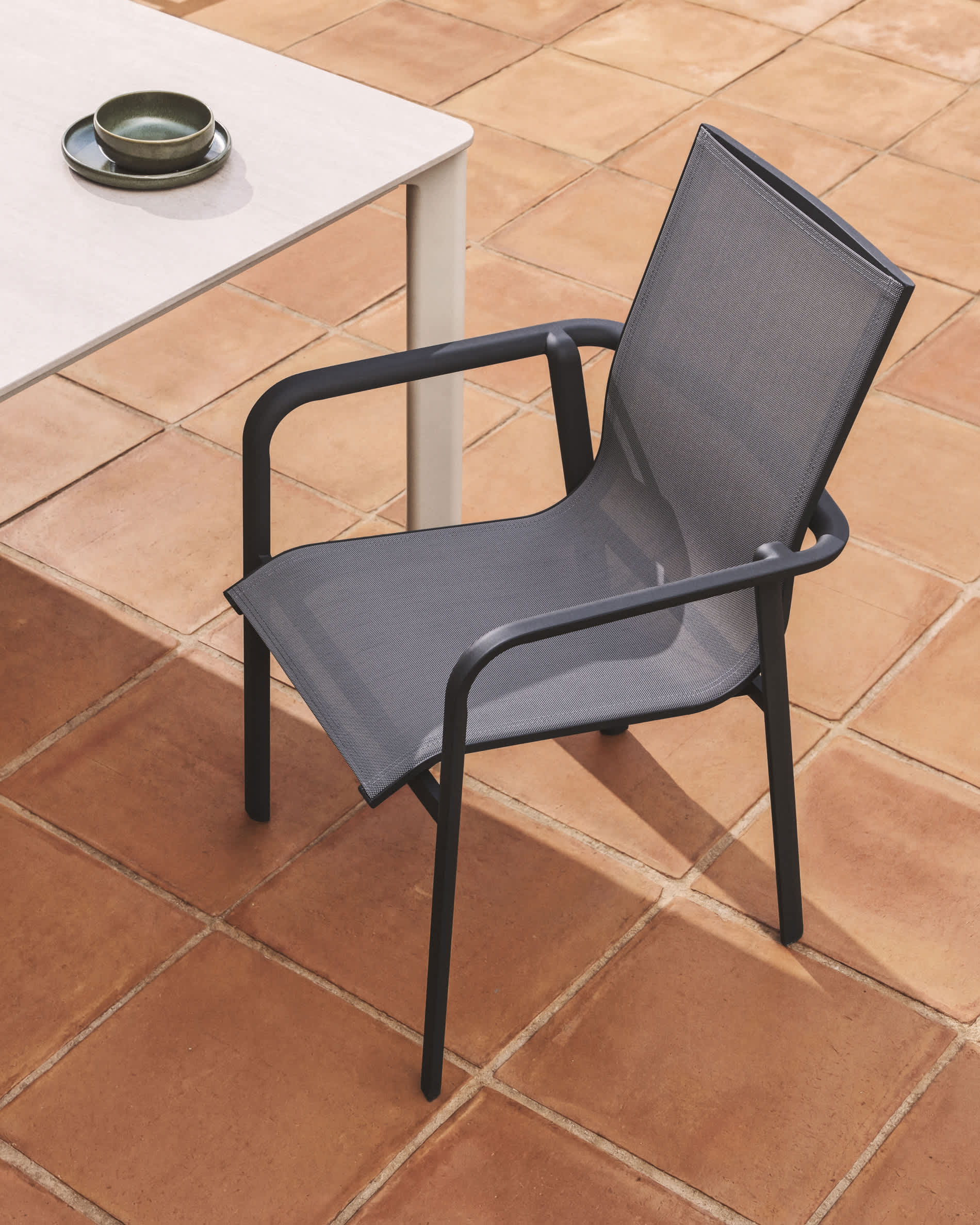Canea stackable outdoor chair in grey texteline and graphite aluminium