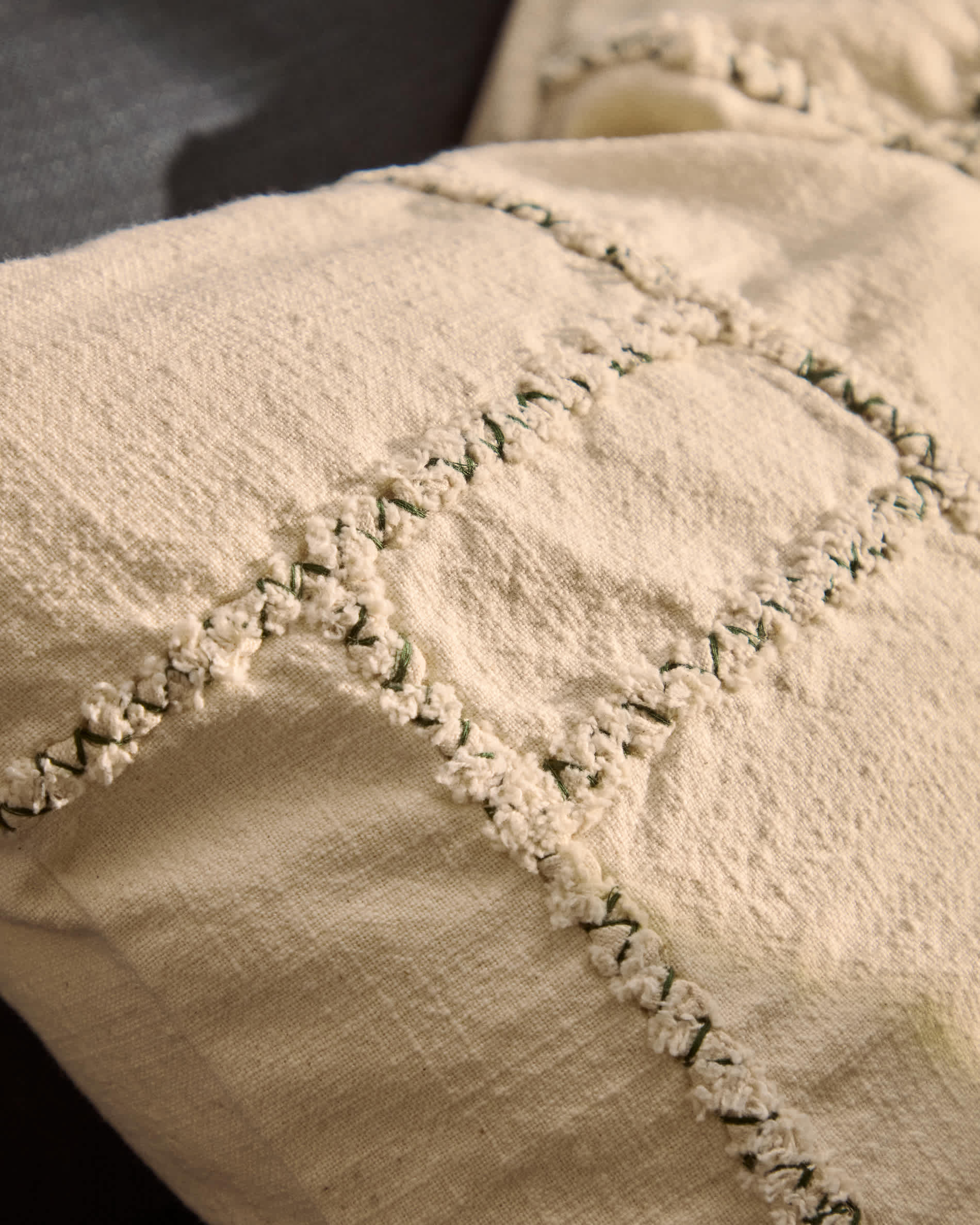 Verion green cushion cover with embroidered geometric detail 45 x 45cm