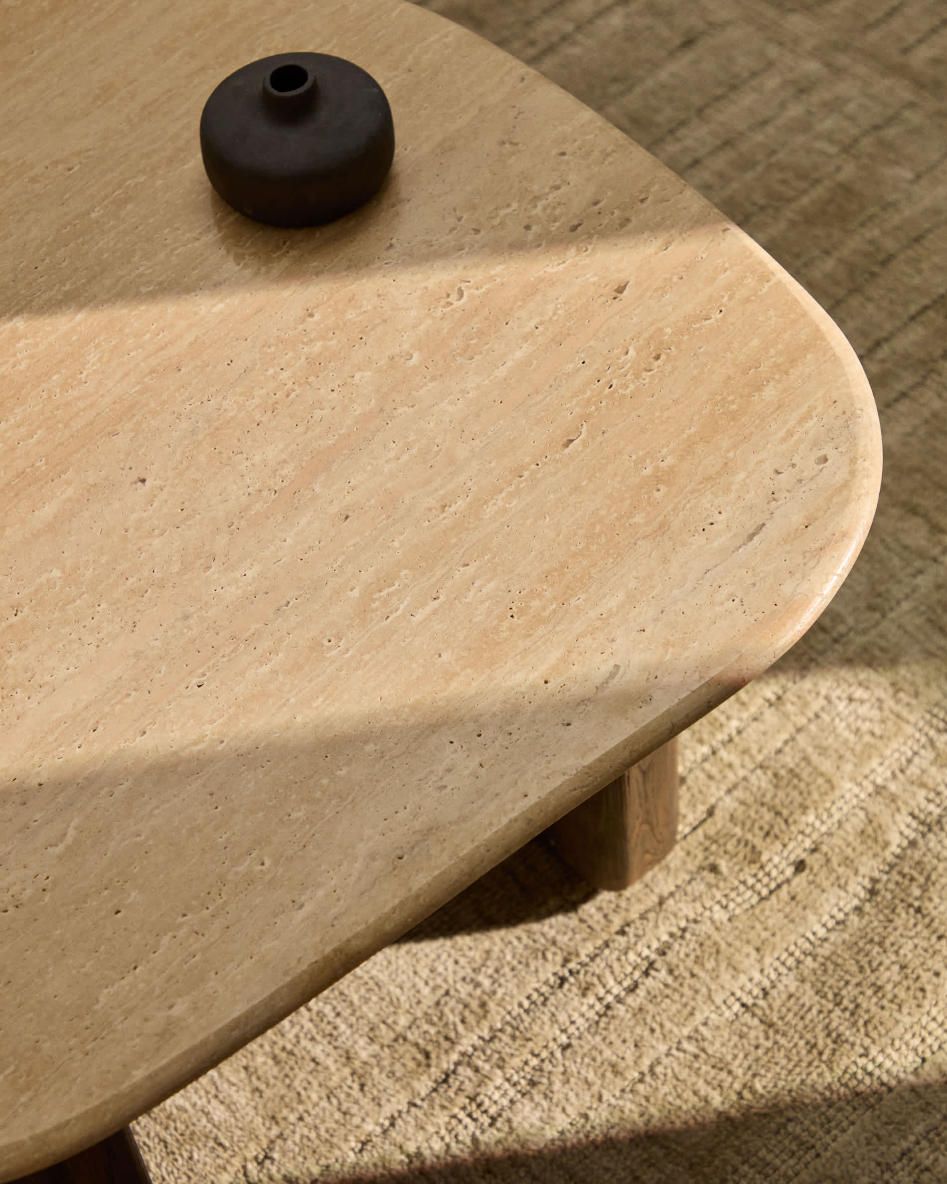 Pirita side table in beige travertine with solid oak wood legs with a dark finish 71 x 70cm FSC 100%