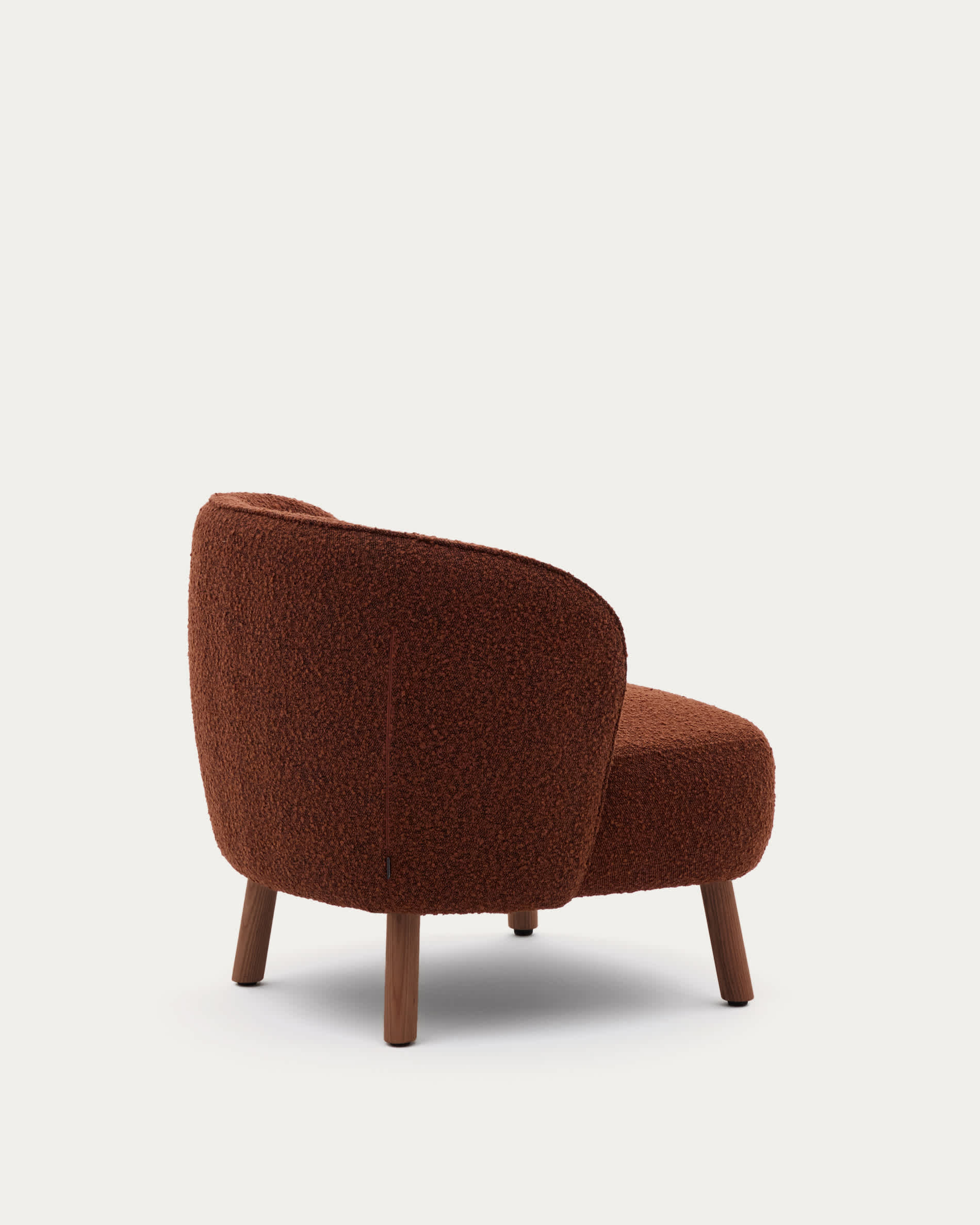 Ulit armchair in terracotta bouclé with solid ash wood legs in a walnut finish