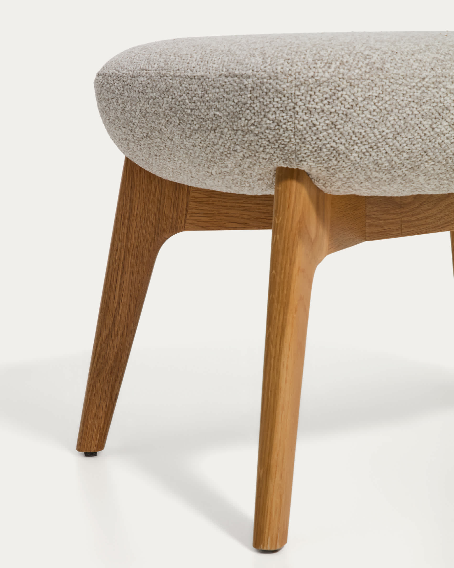 Adiran footrest in beige thick chenille with solid oak wood legs with a natural finish