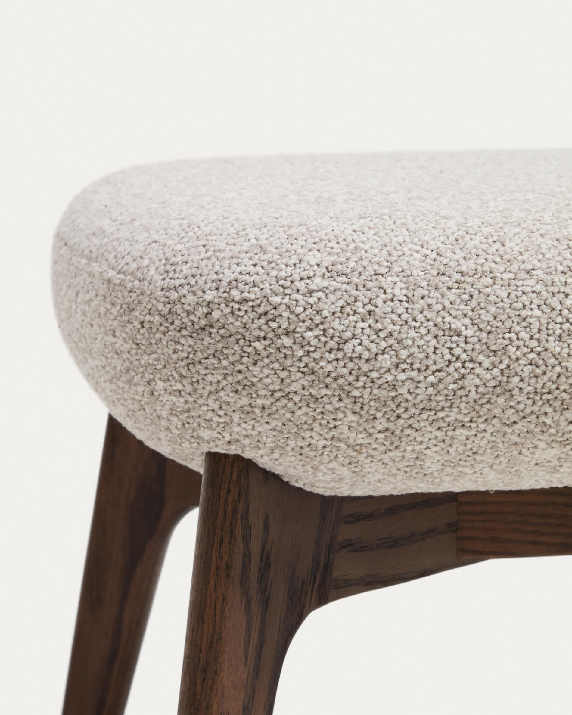 Adiran footrest in beige thick chenille with solid oak wood legs with a walnut finish