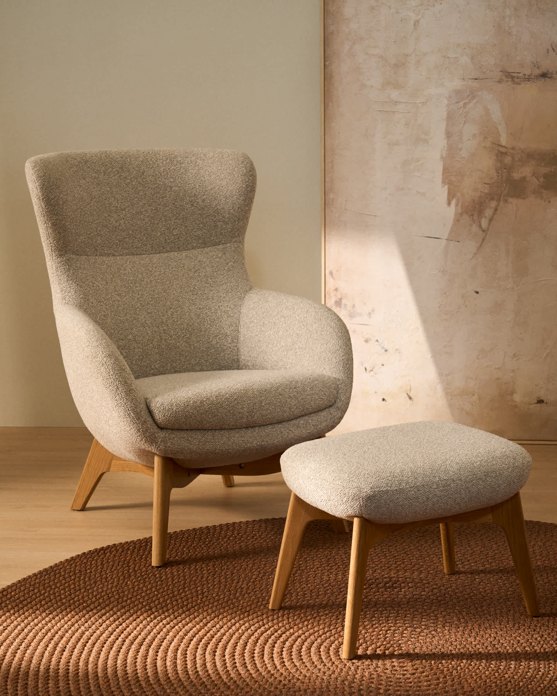 Adiran footrest in beige thick chenille with solid oak wood legs with a walnut finish