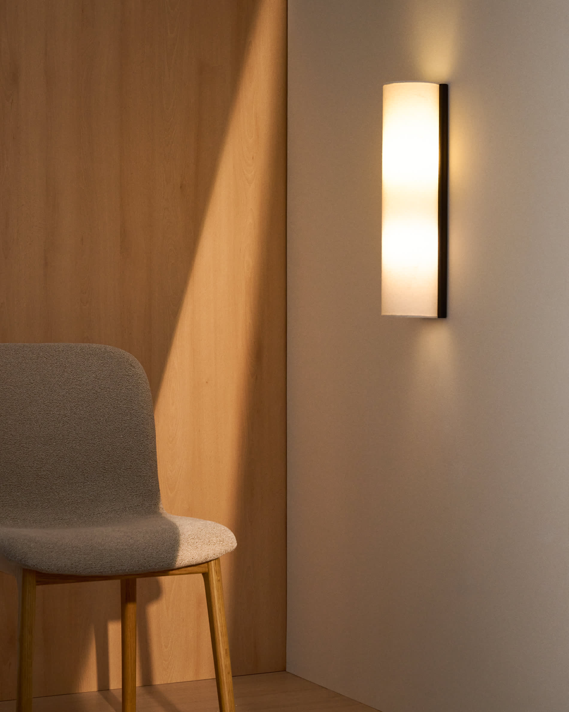 Umbran wall-mounted light fixture made from light brown rubberwood and beige linen
