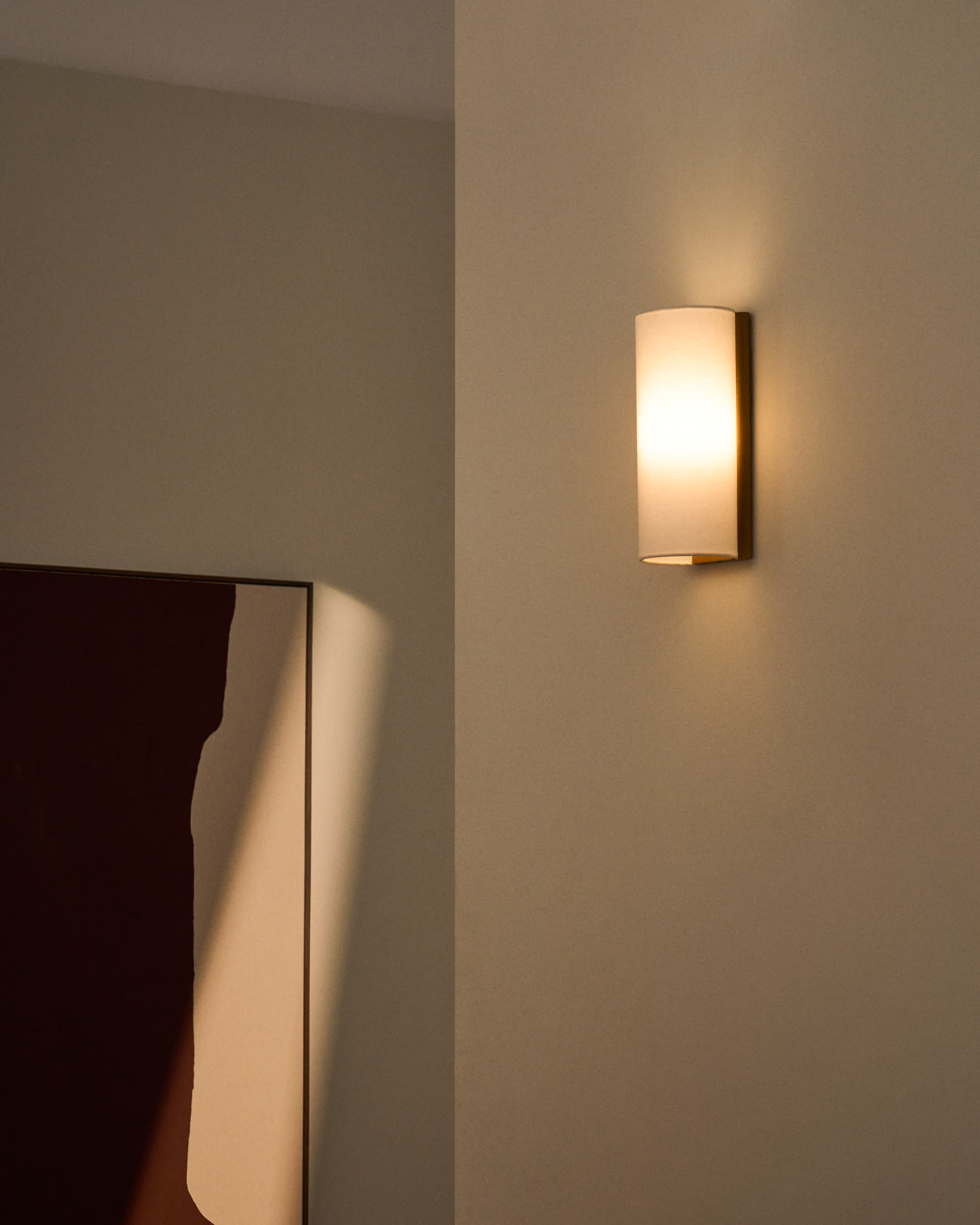Umbran wall-mounted light fixture made from light brown rubberwood and beige linen