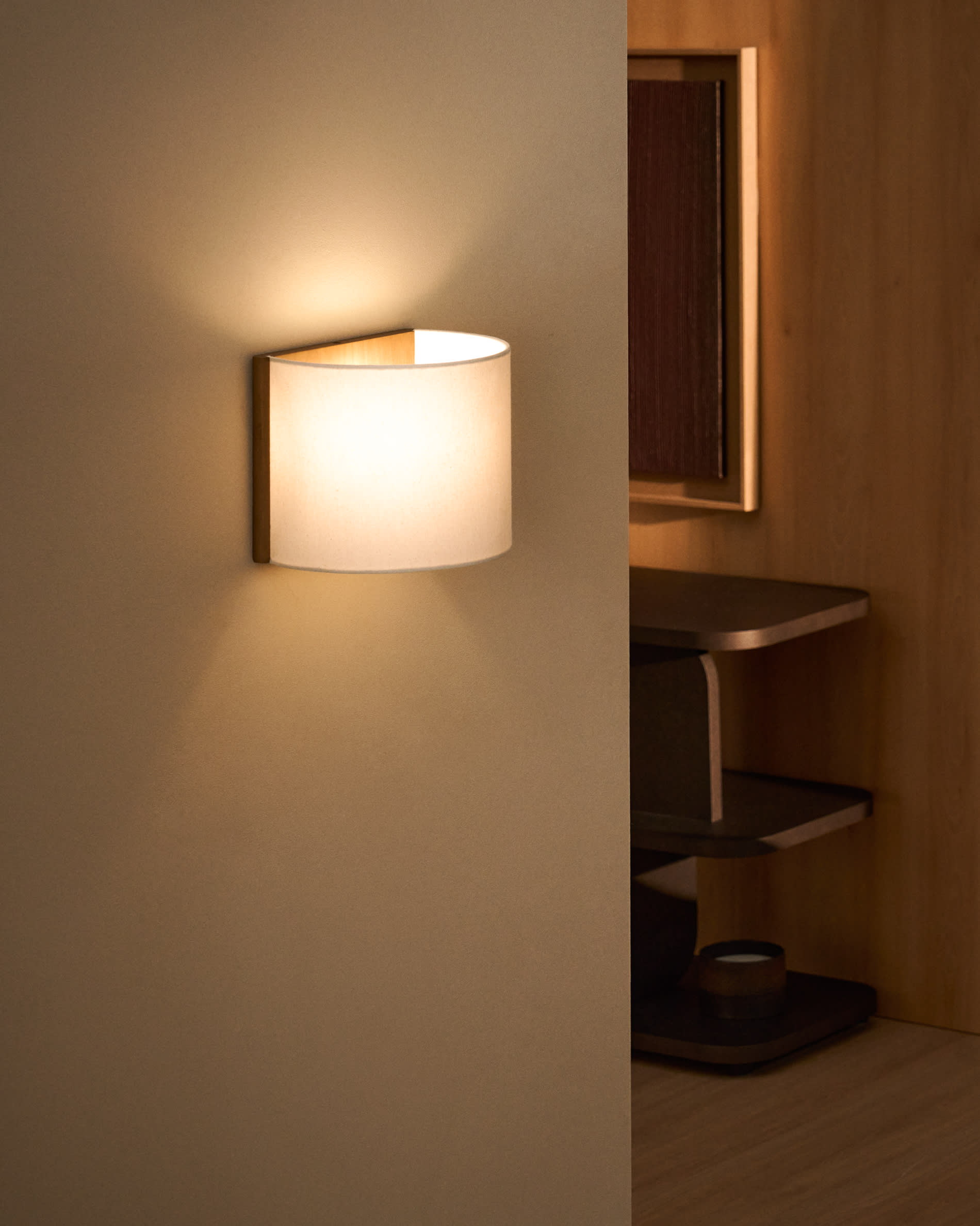 Umbran wall-mounted light fixture made from light brown rubberwood and beige linen