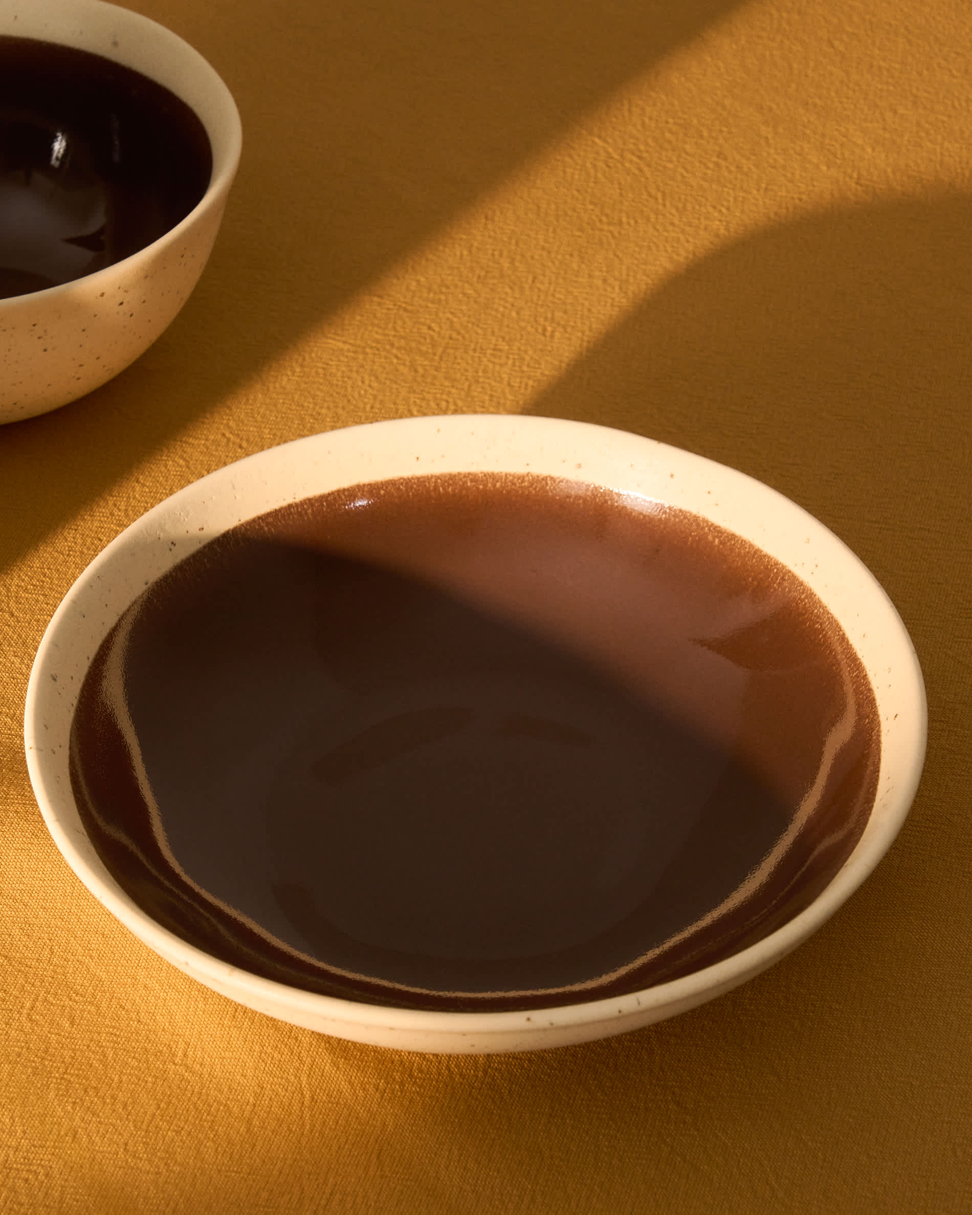 Nale beige ceramic soup bowl with brown bottom