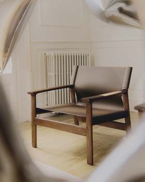 Jan armchair made of dark brown recycled leather fibres and FSC 100% solid ash wood with walnut-coloured finish