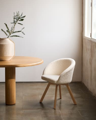 Marvin swivel chair in white bouclé with solid beech wood legs in a natural finish