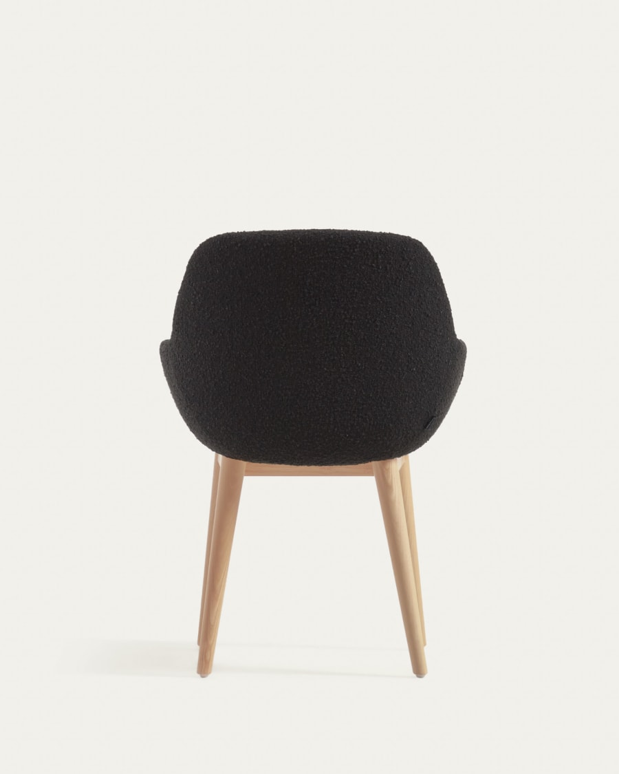 Konna chair in black bouclé with solid ash wood legs in a natural finish
