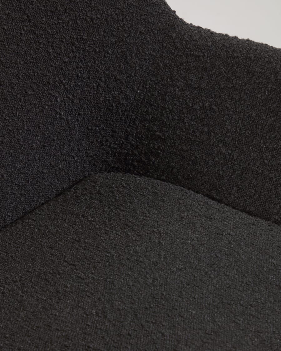 Konna chair in black bouclé with solid ash wood legs in a natural finish