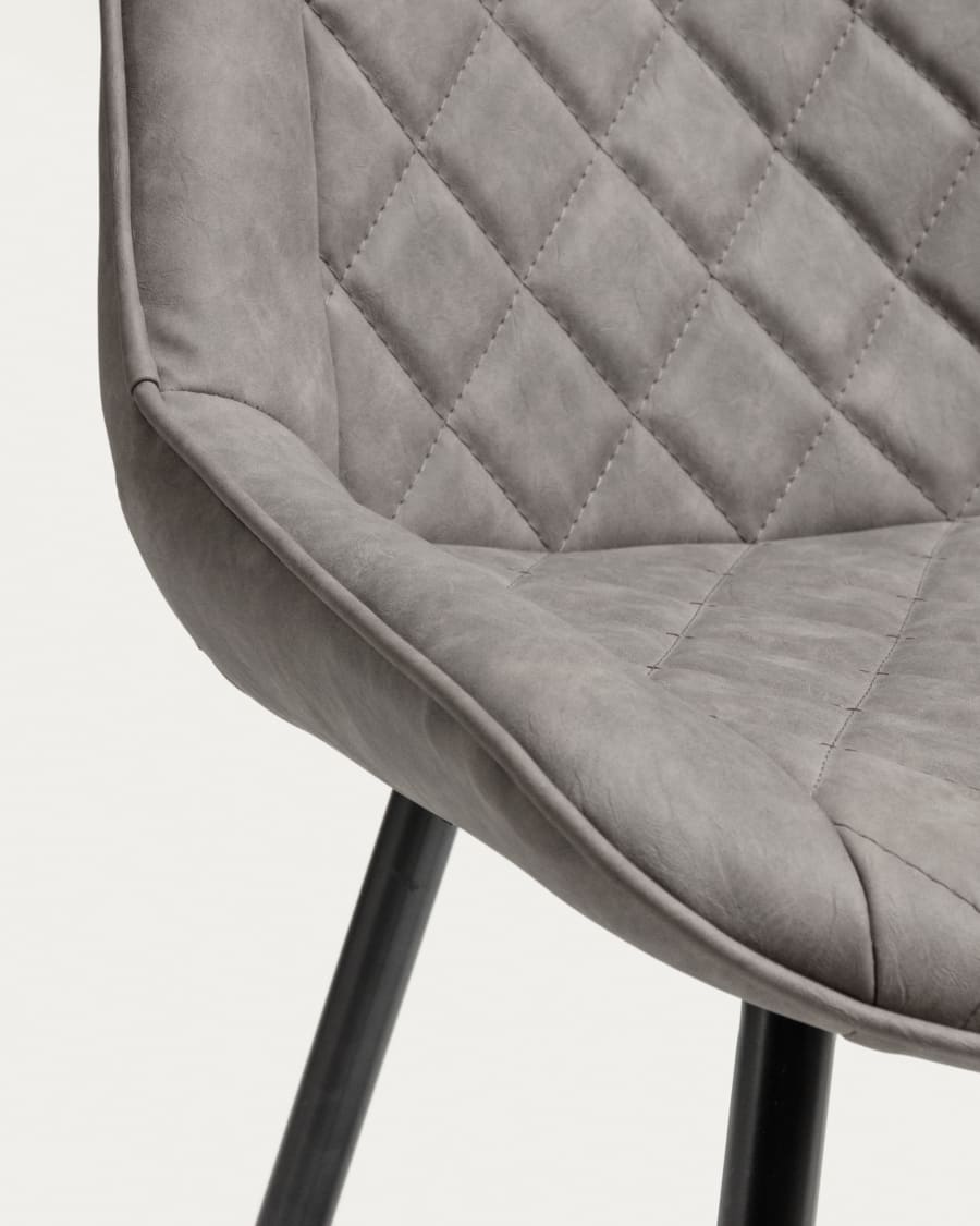 Adelia faux leather chair in light grey, with steel legs in a black finish.