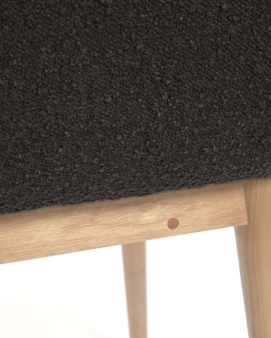 Konna chair in black bouclé with solid ash wood legs in a natural finish