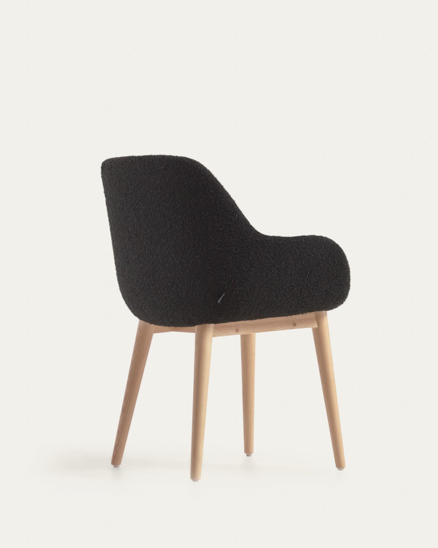 Konna chair in black bouclé with solid ash wood legs in a natural finish