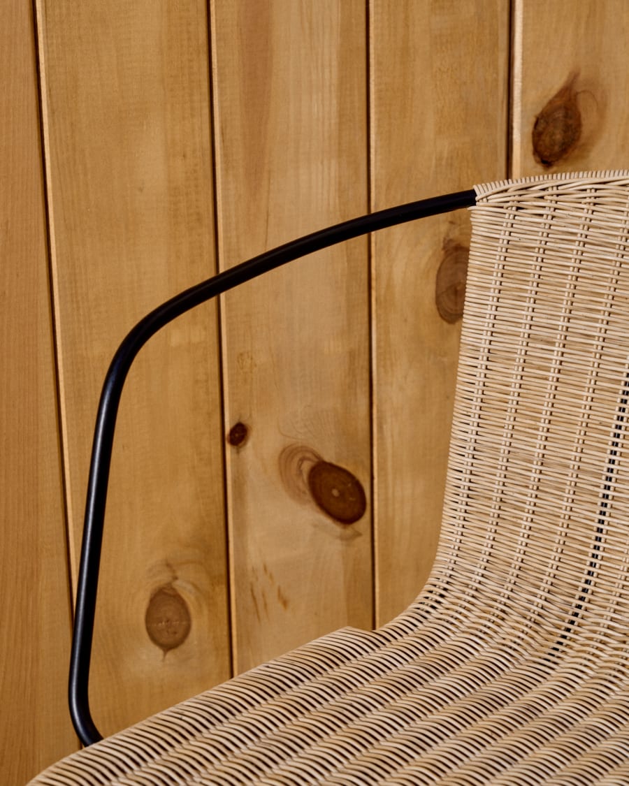 Eltiera stackable chair in synthetic rattan with black steel frame and arms