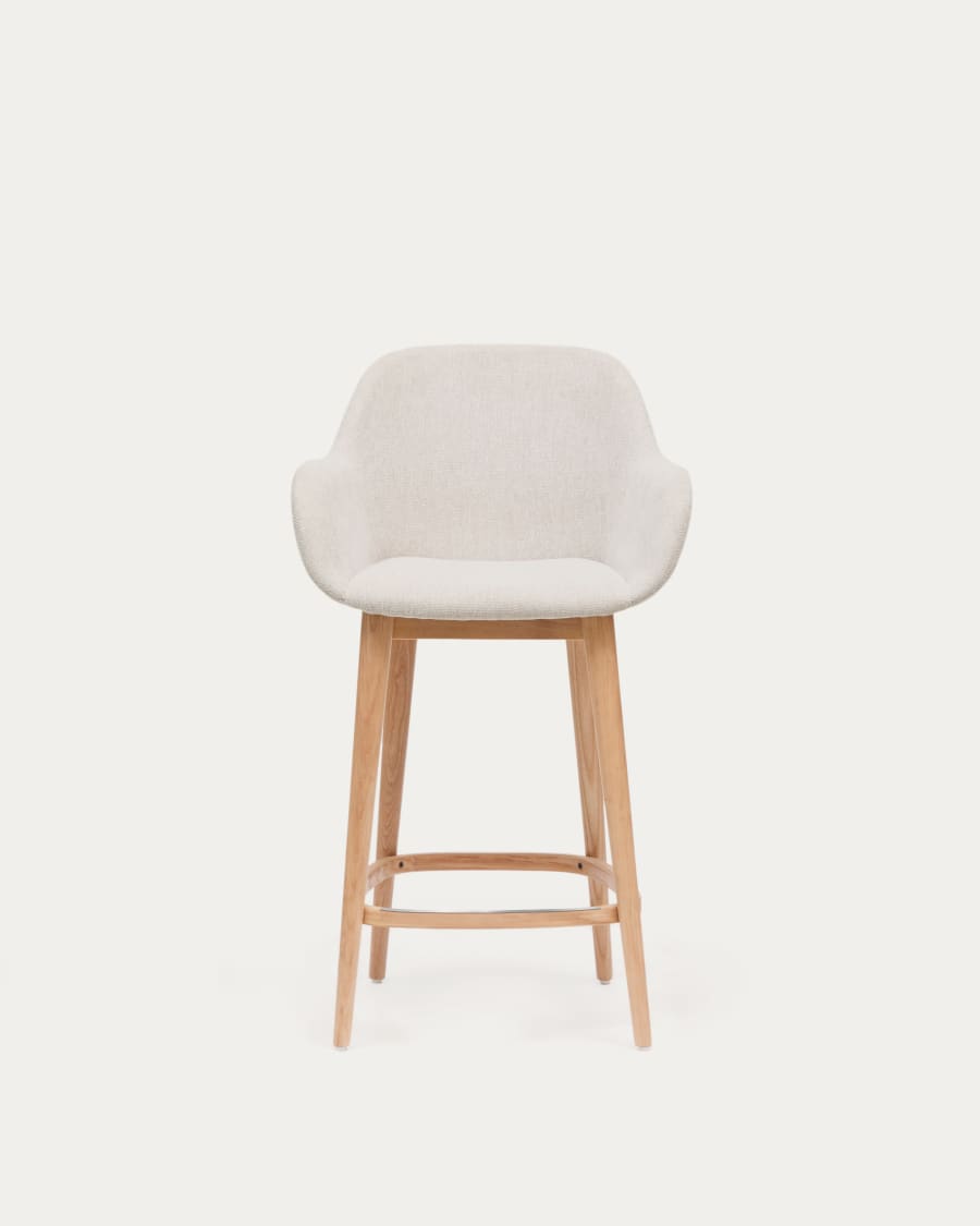 Beigefarbener Hocker Konna mit Beinen aus massivem Eschenholz, helles Finish 65 cm