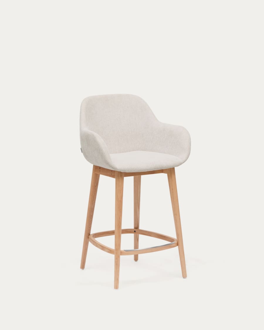 Beigefarbener Hocker Konna mit Beinen aus massivem Eschenholz, helles Finish 65 cm