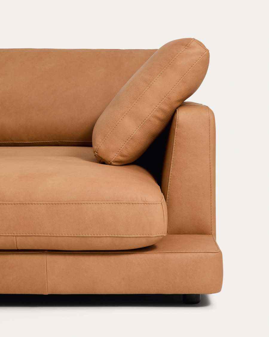 Gros plan du coussin d'accoudoir et de l'assise du canapé Gala en cuir marron clair.
