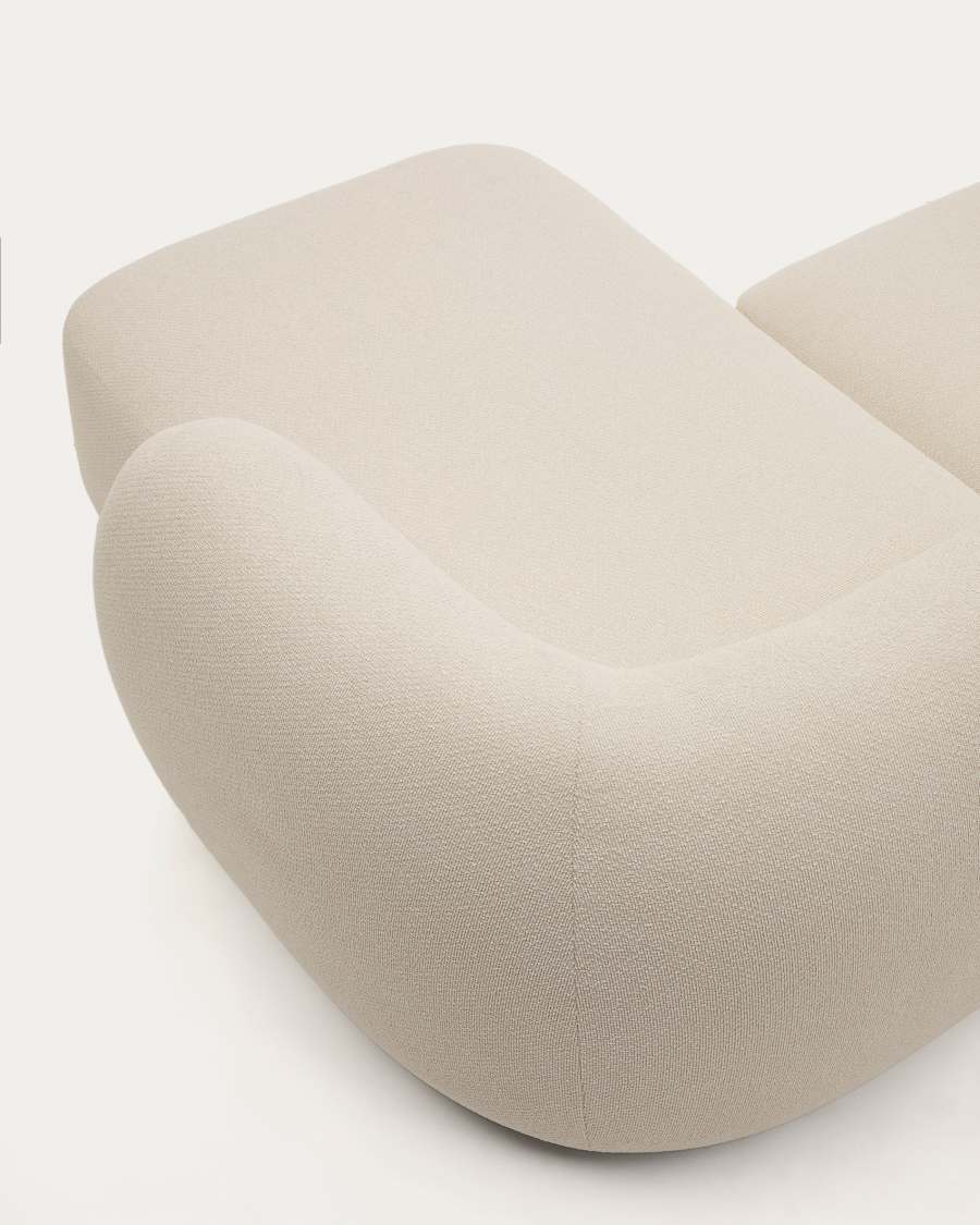 Gros plan de l'accoudoir arrondi du canapé Martina en tissu écru et de l'assise.