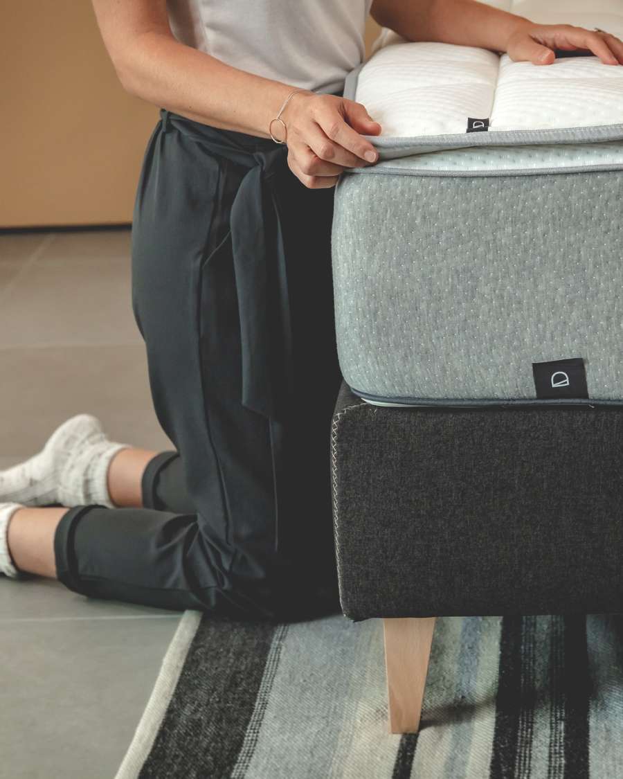 Nikos tall bed base in black with solid beech wood legs for a 150 x 190 cm mattress