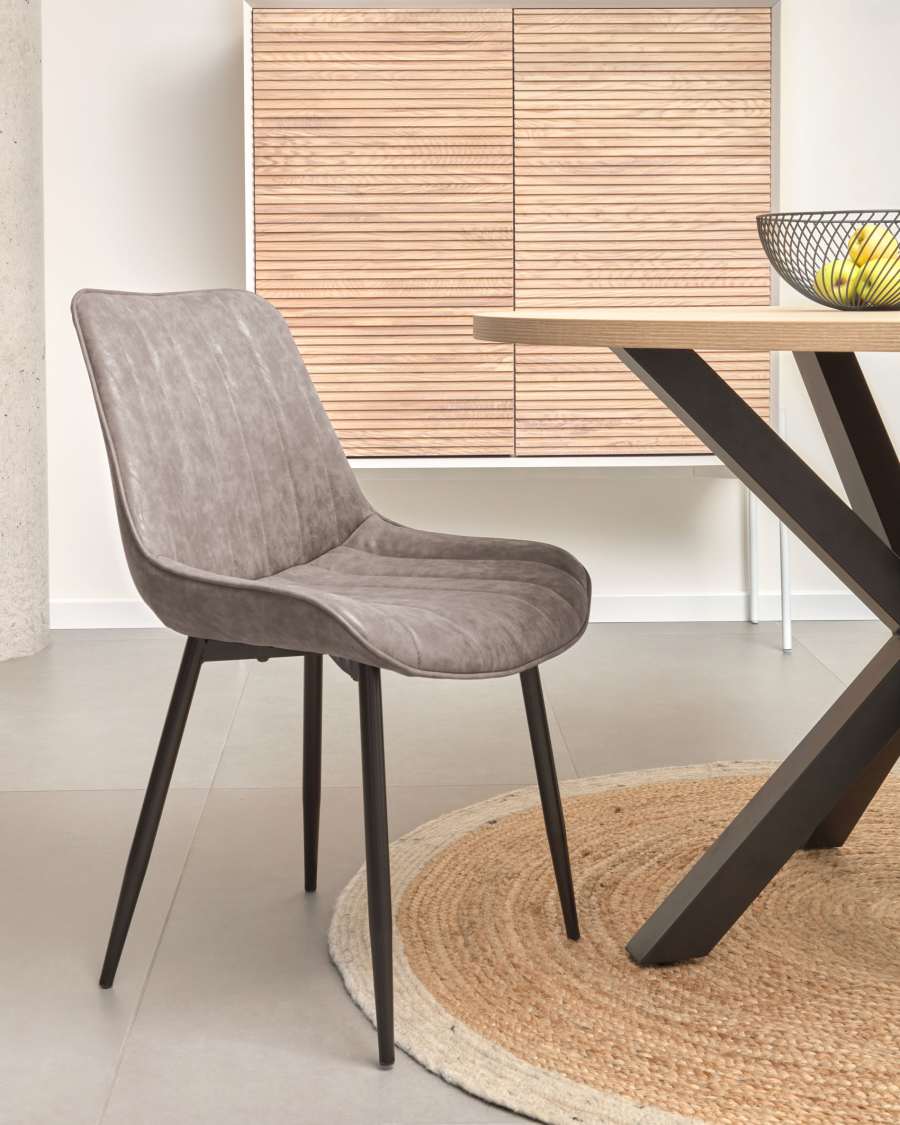 Janis faux leather chair in light grey, with steel legs in a black finish.