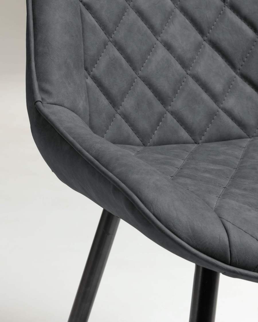 Adelia faux leather chair in dark grey, with steel legs in a black finish.